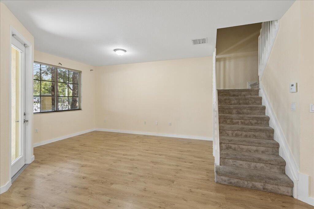 Discover this well-maintained 3-bedroom, 2.5-bathroom townhouse featuring a spacious, open-concept floor plan in a convenient location. The first floor offers durable laminate flooring, an expansive living and dining area, and a versatile flex room perfect for a home office, playroom, or additional sitting area. The bright kitchen features ample cabinetry, generous countertop space, and a functional layout ideal for everyday living and entertaining.  Upstairs, the primary suite provides a private retreat with a double vanity, soaking tub, separate walk-in shower, and generous closet space. Two additional bedrooms and a full bathroom offer plenty of room for family, guests, or remote work. Enjoy the convenience of two assigned parking spaces and a location close to shopping, restaurants, public transportation, schools, parks, and major highways, making commuting and daily errands a breeze.  Whether you're a first-time homebuyer, looking to downsize, or searching for a low-maintenance home, this move-in-ready townhouse offers the perfect combination of comfort, functionality, and accessibility. Don't miss this opportunity to own a beautiful home in a desirable location!