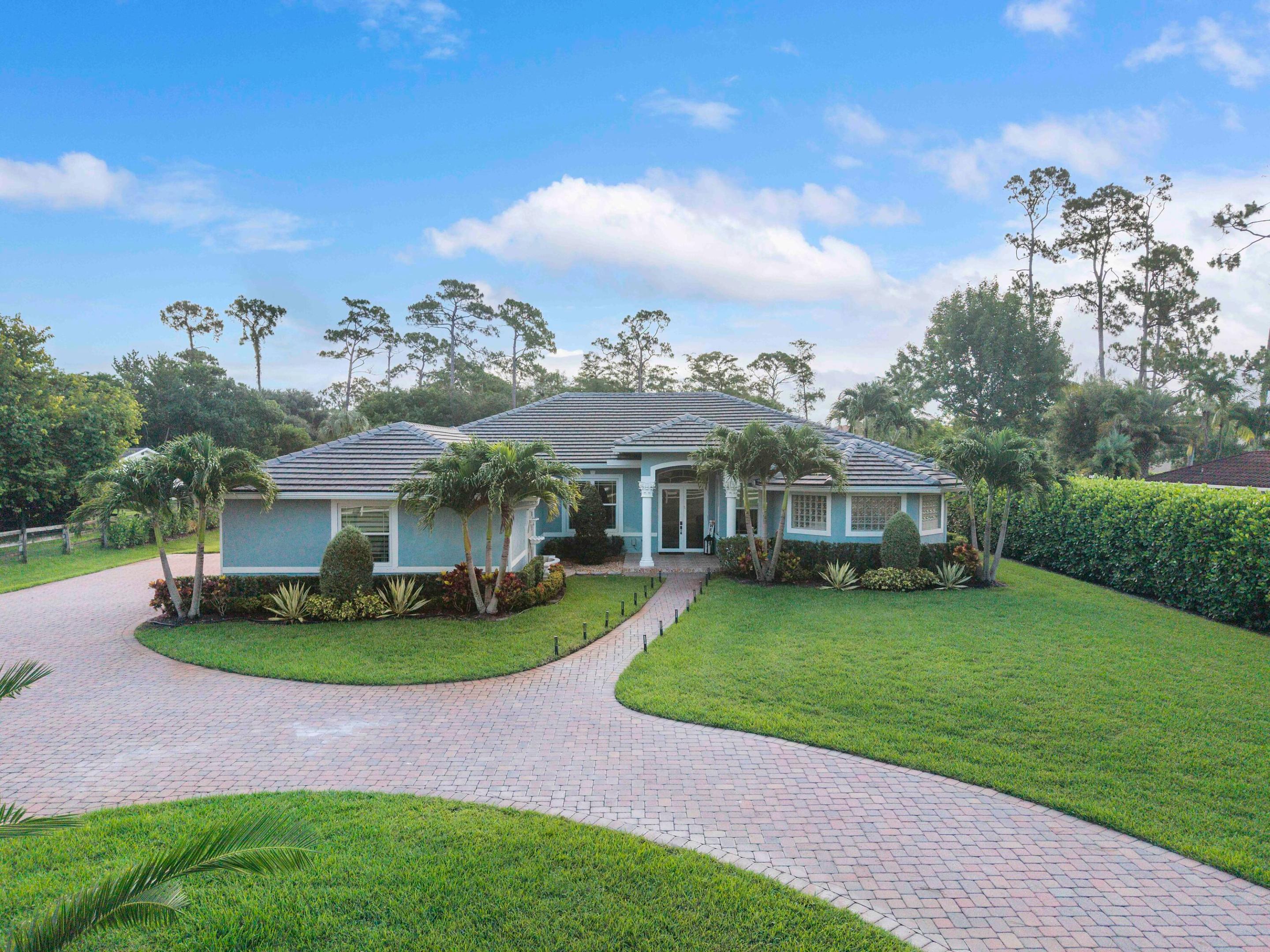 Beautifully updated 4-bedroom, 3-bath with large office/den situated on 1 acre in desirable Pine Tree Estates in Parkland. This move-in ready property features a 2023 roof, 2023 impact windows and sliders, brand-new kitchen appliances, 2021 A/C units, an oversized 3-car garage, and a chef's kitchen with a walk-in pantry.  Additional upgrades include new well and sprinkler pumps, a fully fenced backyard, paver patio, and a lush privacy clusia hedges across the rear of the property. A rare opportunity to enjoy space, privacy, and major upgrades in one of Parkland's most sought-after communities no HOA and A+ rated schools!