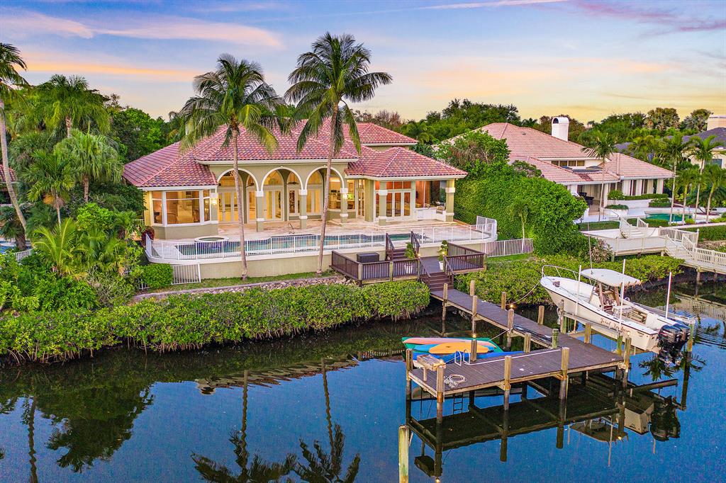 This stunning Custom South facing home with RARE TENNIS MEMBERSHIP, in much sought after Admirals Cove, is situated on 100 feet of water frontage for up to 70' boat.  6 bedrooms, two offices, open kitchen to the main floor family room, a formal living room and formal dining room, exercise room and enormous play room. Wide open floor plan, light, bright, and water views!  White contemporary finishes, blended with some traditional textures. New roof, new garage doors, fireplace, generator, etc. Meticulously maintained by original owner. Amazing opportunity - this won't last.