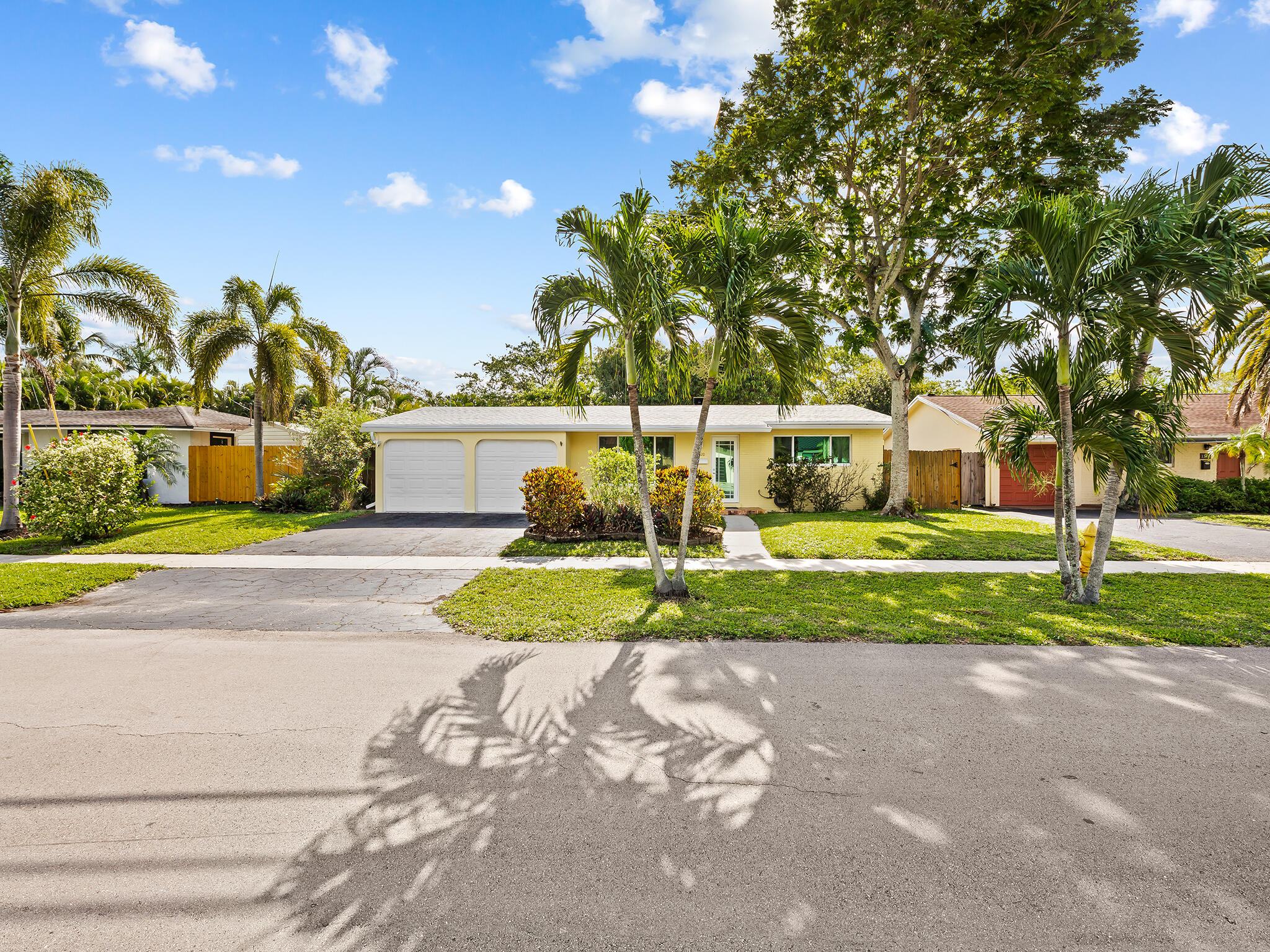 Located in sought-after Plantation Isles, this waterfront residence delivers! Step inside to a bright, open floor plan with tranquil views of your private oasis—featuring a sparkling pool, travertine deck, and a luxurious Jacuzzi tub. The backyard offers great privacy, backing to a lush, tree-filled green space across the canal for a serene, park-like setting. This 3-bedroom, 2-bath split floor plan includes a cabana bath ideal for poolside convenience. Features include a 2025 roof, hurricane-impact doors & windows, 2-car garage and laundry room under air. Boating enthusiasts will appreciate 75' of waterfront and a private 8' wide grandfathered dock, offering ocean access with only one fixed bridge (approx. 9' clearance at high tide). Exterior supplemental storage shed and NO HOA!