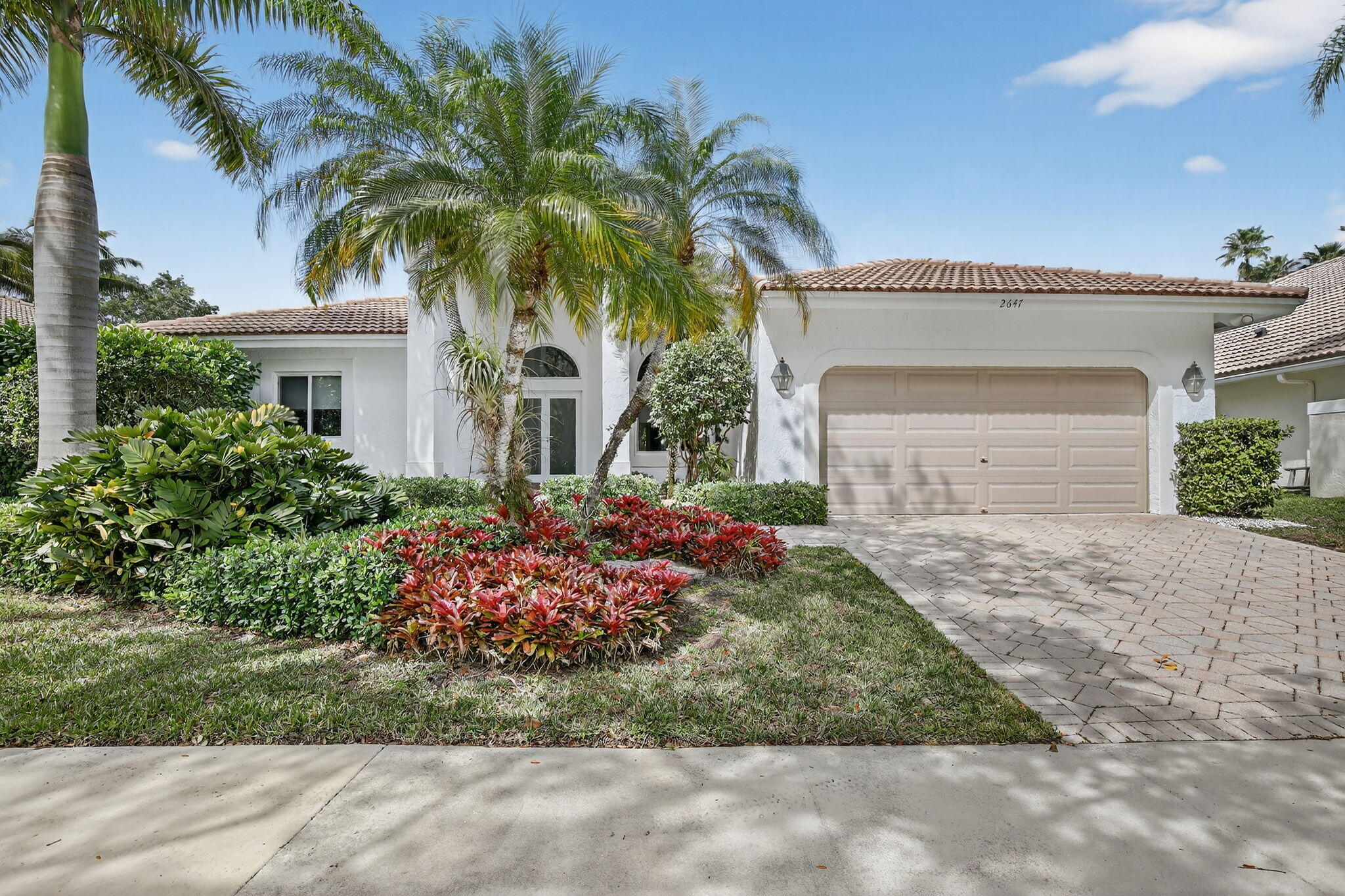 Totally updated kitchen and bathrooms in this four bedroom, 3 bath home w/pool overlooking water & golf course in Grand Oaks in upscale Weston Hills. All impact windows & doors. Newer 2023 roof & exterior just repainted. Remodeled open kitchen features plentiful sleek cherry cabinetry & granite countertops. Miele appliances & wine refrigerator identically faced to match cabinetry. Induction cooktop. High ceilings.Split bedroom plan. All closets with built-ins. Possible potential nursery or office in adjacent room w/walk-in closet off the master bedroom (not included in bedroom count). Master bathroom with separate shower&tub updated with stone & wood cabinetry. More cherry cabinetry in secondary updated bathrooms. Pool area fully fenced.  Golfers welcome! Virtually staged photos included.