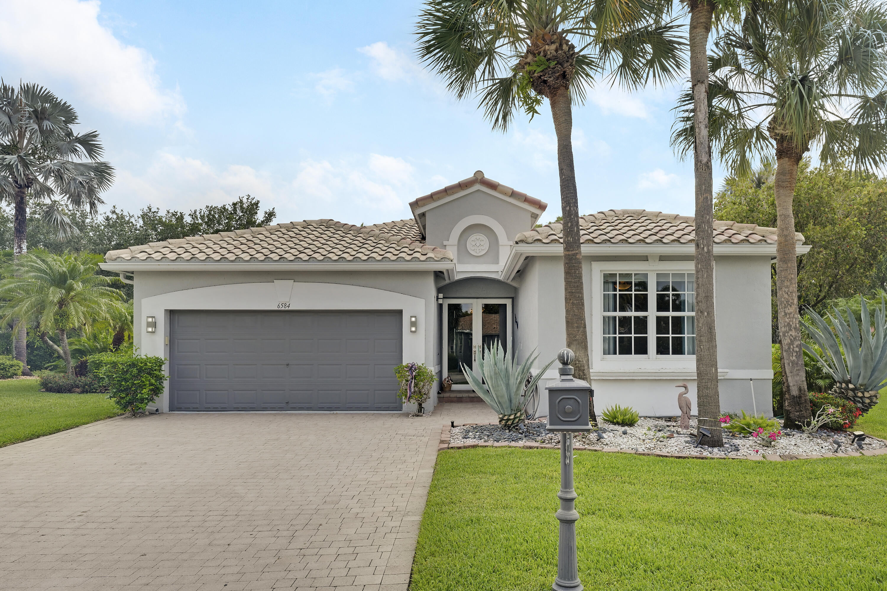 Welcome to this highly desirable Alexander model in Beautiful Bellaggio, ideally situated on a quiet cul-de-sac with exceptional curb appeal and with a large oversized lot. This well-maintained residence features impact glass windows and doors for added peace of mind and energy efficiency. The versatile den/office or third bedroom showcases beautiful custom built-ins that will remain with the home. The spacious laundry room is equipped with a brand-new LG Washer and Dryer along with a convenient slop sink. Additional upgrades include a 2023 Air Conditioner and an epoxy-finished garage floor.  The Kitchen offers Granite Countertops and a Refrigerator that is approximately two years old. The Dining Room mirror and decorative sconce are also included with the sale, adding a touch of elegance and charm.  The Master Bedroom Suite features French doors leading directly to the impressive oversized pool area, creating a wonderful indoor-outdoor lifestyle. The Pool measures approximately 17' x 30' and overlooks the expansive backyard setting, perfect for relaxing or entertaining in the Extended Lanai. The Pool has a Pool Heater from 2023.. This Beautiful home combines comfort, quality updates, and an outstanding location within one of the area's most sought-after communities. The Alexander Model continues to be one of the community's most popular designs due to its efficient layout, generous living areas, and flexible Den space that can serve as a home office.  As you drive through the guarded gates you realize Bellaggio is an Active Community. From its well-manicured grounds and tropical plantings to its 10 Har-tru Tennis Courts, 5 lighted for night play, Bocce Ball, Indoor and Outdoor Pools, separate Fitness Center, Bistro Café, and Pickleball Courts. Both Pickleball and Tennis have Professionals on premises teaching Individuals and Groups. There is a Grand Ballroom featuring Top-notch Entertainment and Events with a full-time "Lifestyle" Director. There are also dozens of clubs, and Activities, Card Rooms and Billiard Room, Arts & Craft Center and much, much more...  This home offers an exceptional opportunity to enjoy Bellaggio's lifestyle living at its finest!