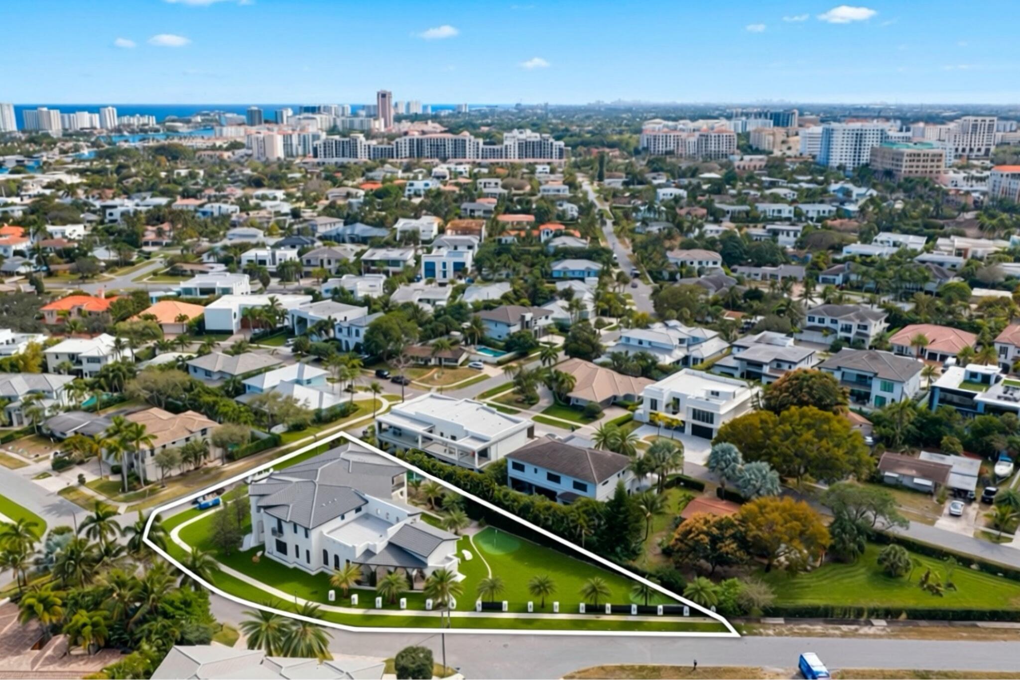 Introducing an extraordinary custom estate in the coveted Boca Villas neighborhood—referred to as "The Golden Triangle"— just moments from world-class dining, shopping, and entertainment at Mizner Park and Royal Palm Place, and less than a mile from the beach and the Boca Raton Resort and Spa.    Situated on a rare ½-acre corner lot, this remarkable residence offers an unparalleled blend of sophisticated architecture, resort-style amenities, and exceptional indoor-outdoor living.    Spanning 8,276 square feet under air, 11,152 total square feet and 2,136 square feet of covered outdoor living space. This stunning home features 7 bedrooms, 8.5 bathrooms.    Thoughtfully designed for both luxurious everyday living and grand-scale entertaining. The residence includes two primary suites, an office, gym, formal dining room with butler's pantry, two full laundry rooms, an elevator, and multiple indoor and outdoor gathering spaces.    Inside, refined finishes and elegant architectural details define the interiors. Rich oak and marble flooring complement soaring ceilings and a dramatic 12-foot fireplace, while expansive impact glass windows, doors, and sliders flood the home with natural light.  A temperature-controlled wine room, two beverage bars, 2 morning bars and an oversized loft with private balcony with exterior stair access to the pool and cabana.     The chef's kitchen is both beautiful and functional, featuring premium appliances including a 60" BlueStar professional range with custom ventilation, 72" refrigeration, built in Miele coffee machine, and dual wall ovens.   A fully built-out walk-in pantry with its own sink and dishwasher adds convenience and additional preparation space. An extra-large island with seating for 8 creates a great gathering space for entertaining.     Designed to embrace the South Florida lifestyle, the property comes complete with an exterior dining area, summer kitchen, and an outdoor fireplace. The spectacular backyard oasis is highlighted by an "L"-shaped resort-style pool with hot tub, 12 foot waterfall and sun-shelf.    The grounds are truly exceptional, offering amenities rarely found in a residential setting, including an 8-hole chipping and putting golf course with bunkers and a water feature, with room to add a private Sports Court (pickleball), or a guest house, detached garage ideal for additional vehicles, recreational toys, or storage.    The Cobblestone driveway and a limestone entrance patio, and a striking four-sided waterfall feature at the front entry create a memorable arrival experience, framed by two majestic 25+ foot live oak trees.   The first-floor primary suite offers a tranquil retreat with direct access to the patio and backyard through the double French doors. The suite features his-and-hers oversized walk-in closets, a built-in vanity, and a luxurious spa-inspired bathroom with a freestanding soaking tub and dual rain shower heads.    Upstairs, a VIP primary suite enjoys balcony access with exterior stair access to the pool and cabana area, along with a spacious walk-in closet and an additional flexible space ideal for a private gym or office.    Additional highlights include three garage spaces (two-car and separate one-car garages), impact-rated glass throughout.    Perfectly positioned just moments from Boca's premier dining and shopping, under a mile from the beach, and minutes from the Boca Raton Resort & Club, this one-of-a-kind estate represents the ultimate in luxury living in one of Boca Raton's most desirable neighborhoods.