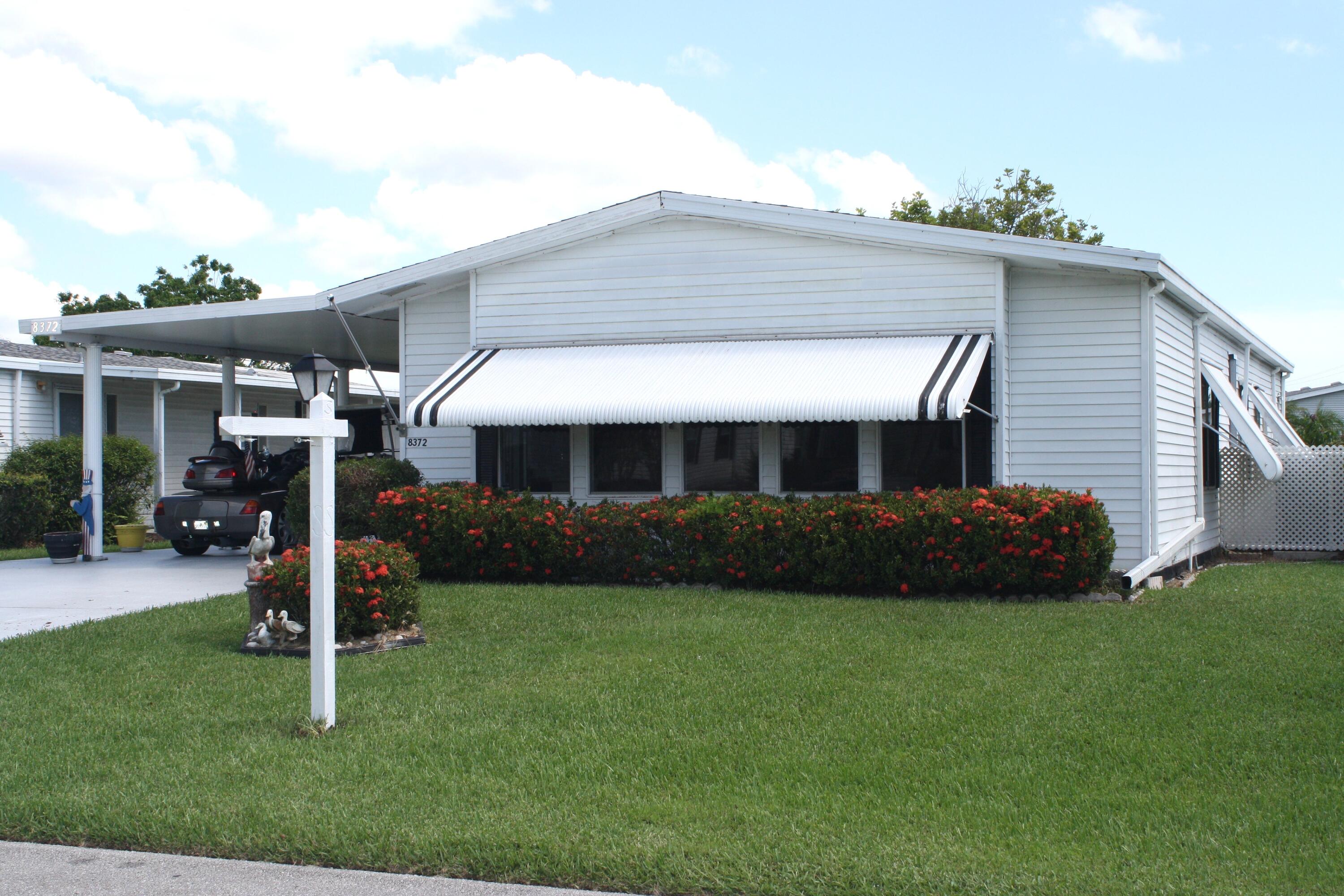 LAND OWNED -  Spacious & Open Floor Plan, this 2/2 has large island kitchen,  and many updates which includes AC 2023, New AC Duct work under the home, 2024 vapor barrier, new 2025 vinyl  plank flooring in den, kitchen, living room and dining room.   Subfloor was replaced in the kitchen, laundry room, hall, guest bath and den with 3/4 inch plywood.  Large enclosed glass porch with new carpet.  HOA  includes cable, internet, trash and access to all the amenities. Savanna Club activities include an 18-hole golf course, 3 pools, 3 exercise rooms, an on-site restaurant, a theater, pickleball, billiards, tennis, and numerous other activities to enjoy.