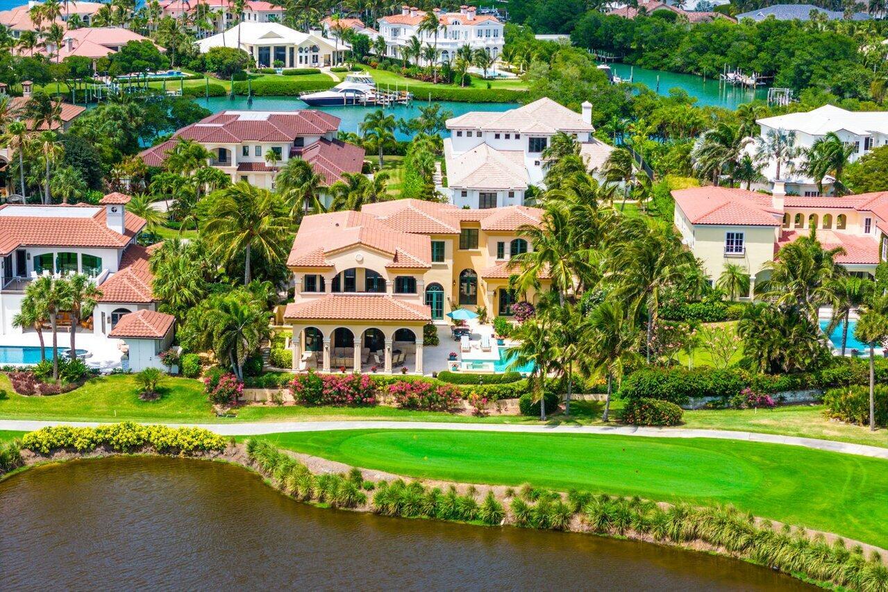 Step into timeless elegance! This magnificent home boasts unparalleled craftsmanship. Experience grand living w a 24' living room ceiling, exquisite dining room columns, & a gourmet kitchen featuring glazed cabinetry, granite countertops, & top-of-the-line appliances. Retreat to the master suite w vaulted ceilings, detailed molding, and breathtaking lake and golf course views. Entertain in style with three luxurious guest suites, a covered patio adorned w columns & travertine floors, & a butler's pantry complete w a 2nd dishwasher & wine storage. Rest assured w impact windows & a convenient elevator. New roof was installed in 2022. Sailfish Point offers the ultimate Florida resort lifestyle w/ its oceanfront country club, fine & casual dining, Har-Tru tennis courts, Jack Nicklaus ''Signature'' golf course, state-of-the-art fitness center & spa, helipad, 1.5 miles of gorgeous beach. Sailfish Point is also located within minutes of a private airport w/ US Customs on-site - Witham Field