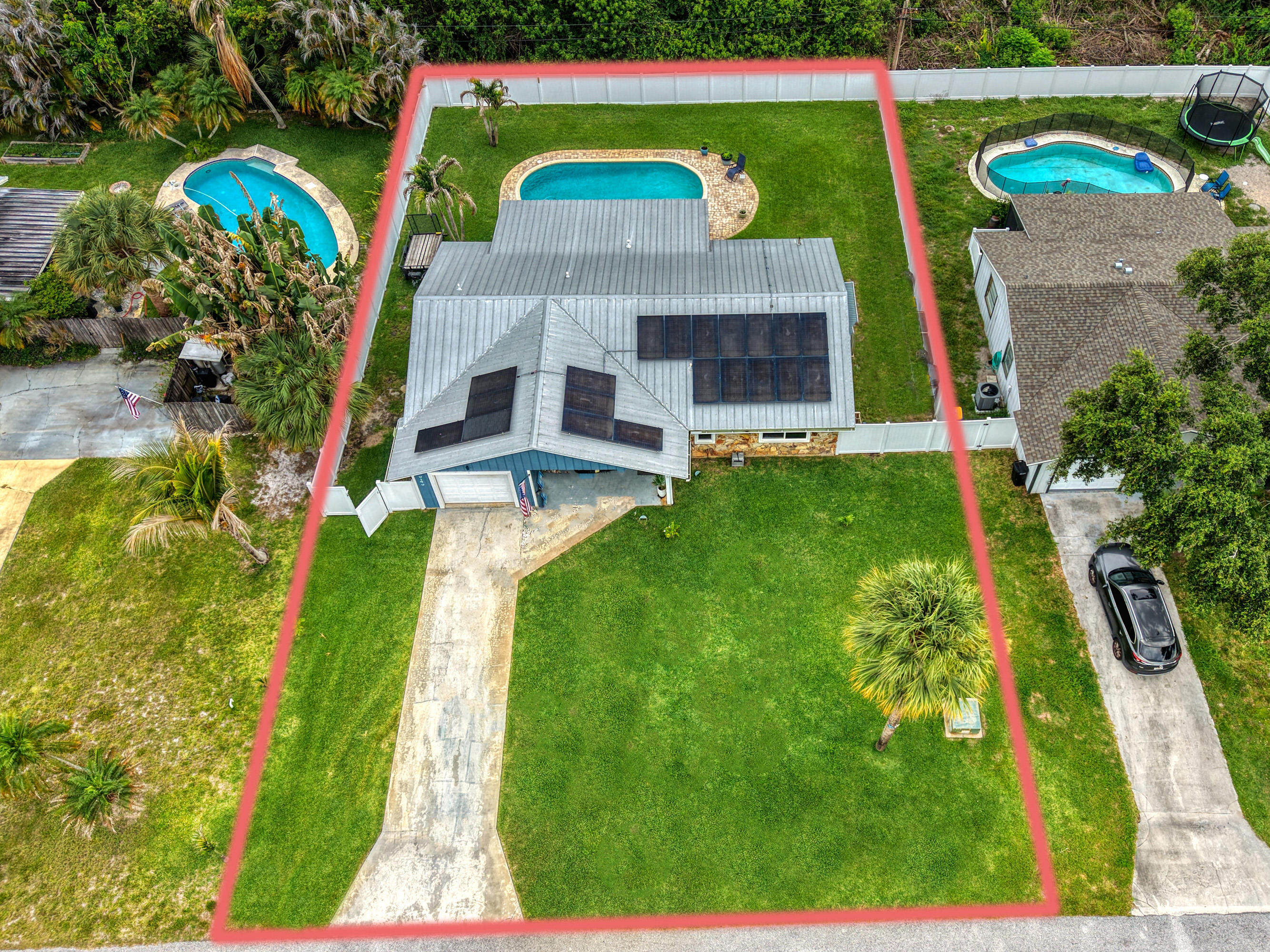 No HOA. No restrictions. Metal roof. Owned solar. Brand new septic. Hurricane impact windows throughout. Every major system upgraded - every major expense already handled.  Step outside to a private oasis: 15x30 pool, gorgeous pool fence, lush lawn, fully fenced yard with room for boats, trailers, and RVs. No one telling you what to do with your property.  Inside: split bedrooms, cathedral ceilings, updated granite kitchen with stone backsplash, open living area that flows to the pool. County-only taxes with homestead exemption. Solar significantly reduces your electric bill.  Minutes from Hobe Sound Beach, Jonathan Dickinson State Park, golf, and major commuter routes.  This one has it all and it's been invested in. Come see it.