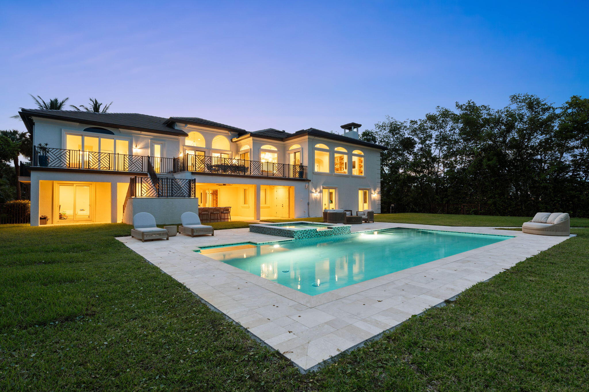 CLOSED PRICE REFLECTS NETSALE - Offered fully furnished & sold turnkey, this gated Sewalls Point estate was completely reimagined in 2022 with hand-selected materials by FireFinish Interiors & additional bespoke finishes by Hurd Homes. Set on 1.25 acres with 152 feet of direct Indian River frontage, the home combines architectural precision with the finest modern comforts.  Inside, picture-frame windows flood the interiors with natural light & frame panoramic water views. The open floor plan showcases marble & porcelain finishes throughout, with every bedroom designed as an en suite retreat. The Primary Suite commands a front-row seat to the water, featuring a spa-like bath adorned with marble & porcelain tile crafted to resemble teak floors without the upkeep.