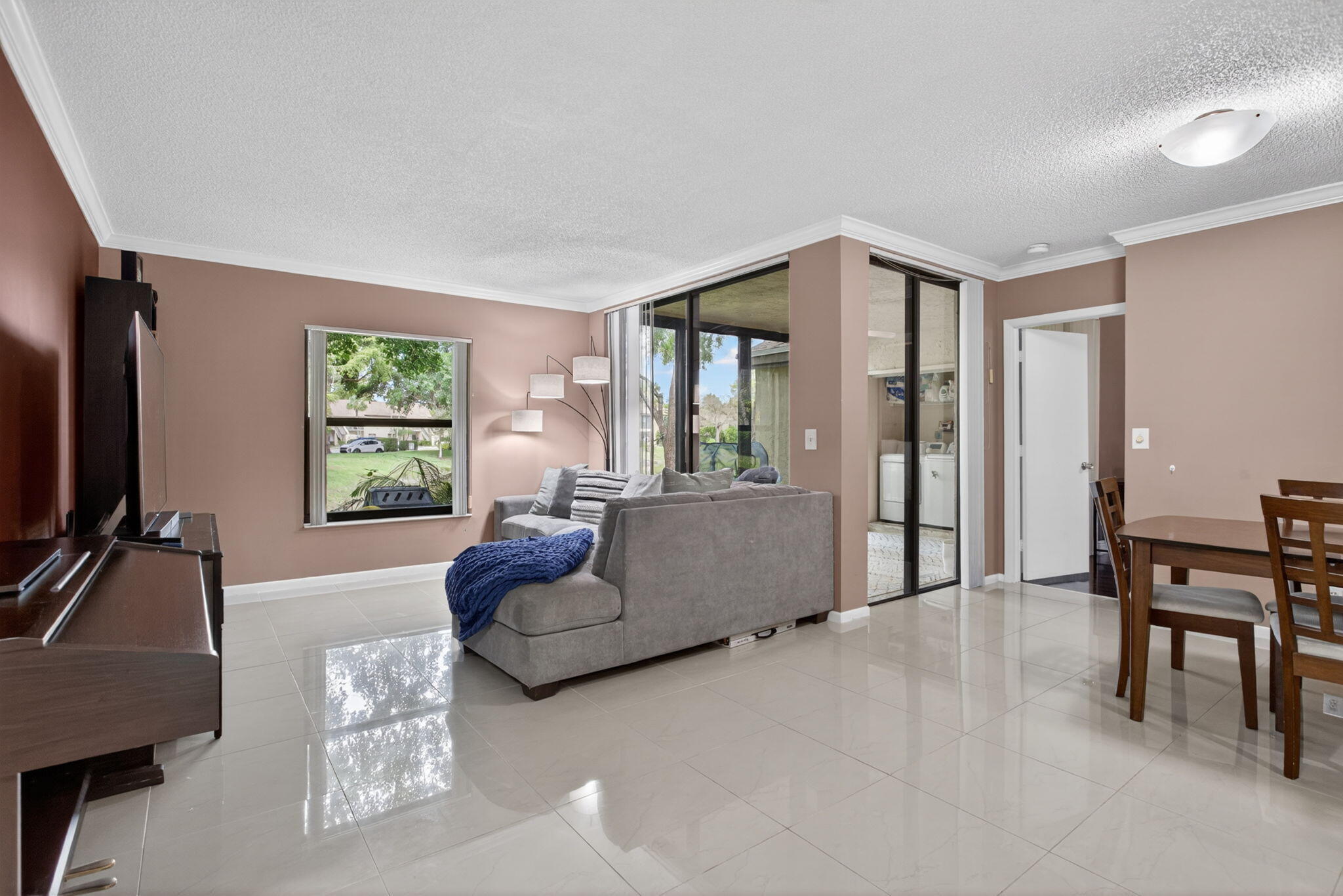 Enjoy effortless South Florida living in this beautifully updated Township residence. This two-level building offers the rare benefit of being exempt from most Florida condo regulations. The association allows rentals! Inside, you will find elegant porcelain tile, a modern kitchen with granite countertops, and smart stainless appliances. Every detail is handled, including full impact glass, a brand-new 2025 A/C, and a new in-unit washer and dryer. Relax on your screened patio with serene canal views. The building features a brand-new roof, and all assessments are fully paid. With parking right at your front door and access to incredible pool, tennis, and pickleball courts, this move-in-ready home perfectly balances modern updates with the comfort you deserve. This home is occupied by the seller. Please contact the agent directly for showing dates and times available.