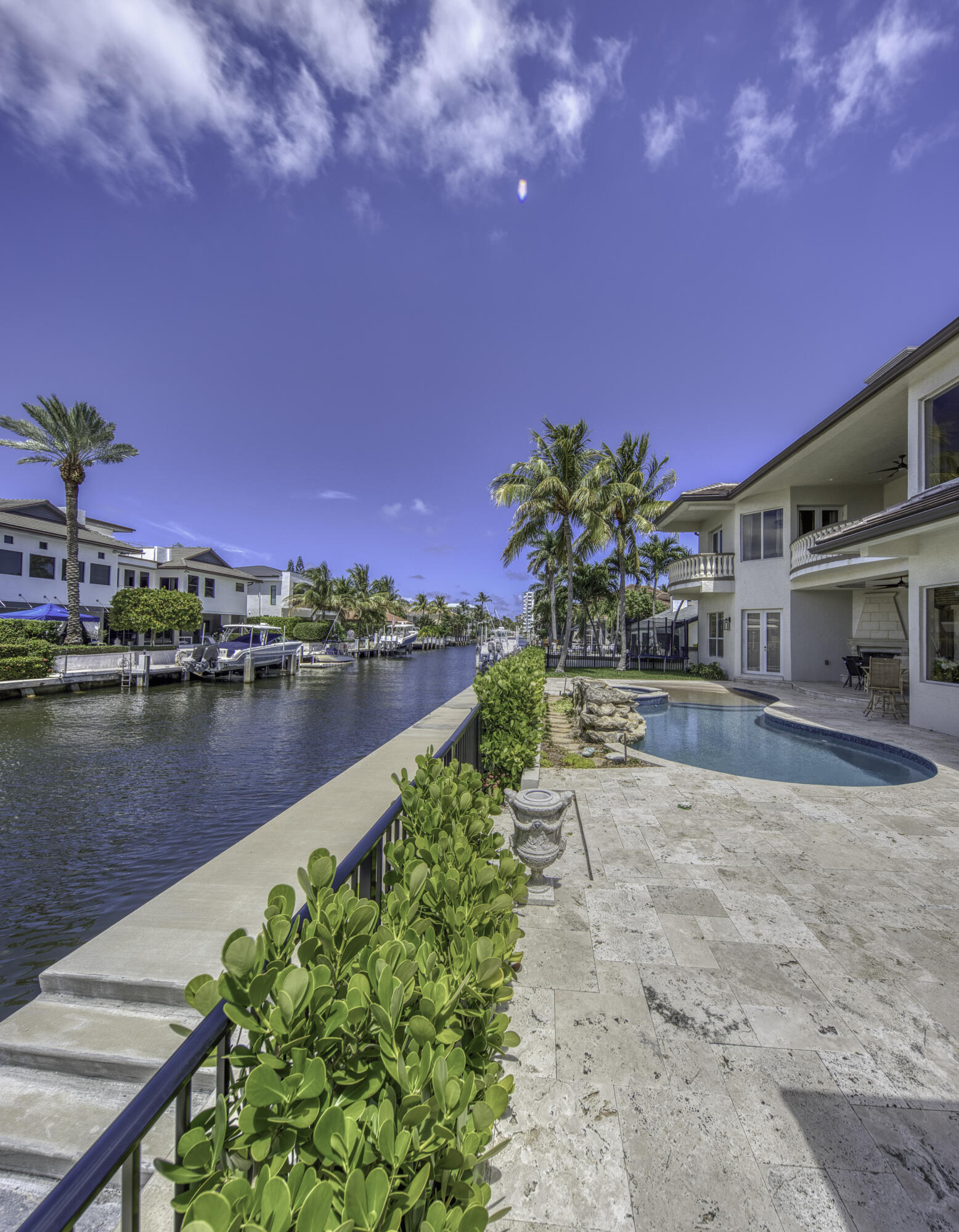 Bring your boat — or multiple boats — to this exceptional deep-water Intracoastal estate in beautiful Delray Beach, nestled within one of the area's most exclusive neighborhoods. Designed for luxury waterfront living, this magnificent residence offers five spacious bedrooms plus a private office and dedicated media room, along with 6.5 impeccably appointed baths. Dramatic two-story soaring ceilings create a grand sense of scale and elegance throughout multiple living spaces, while expansive interiors seamlessly blend sophistication, comfort, and the ultimate South Florida lifestyle This extraordinary deep-water Intracoastal estate in beautiful Delray Beach, perfectly positioned within one of the area's most exclusive waterfront neighborhoods with no HOA. Designed for the ultimate South Florida lifestyle, this spectacular residence offers 5 bedrooms plus a private office and custom media room, along with 6.5 luxurious bathrooms.  Grand two-story ceilings create dramatic elegance throughout multiple living spaces, while double master suites provide exceptional comfort and flexibility. The home is loaded with resort-style amenities including a gourmet chef's kitchen with premium upgrades, stunning sunken beverage bar, billiard loft, temperature-controlled wine cellar, private elevator, dedicated fitness room, and relaxing sauna.  Enjoy seamless indoor-outdoor living with both interior and exterior fireplaces, a custom tiki retreat, and an incredible beach-entry pool with spa/hot tub overlooking the water. Boating enthusiasts will appreciate the deepwater dock with direct Intracoastal access, while car collectors will love the oversized garage complete with an additional auto lift.  Every detail of this remarkable estate was thoughtfully designed to deliver luxury, comfort, entertainment, and unforgettable waterfront living — and more