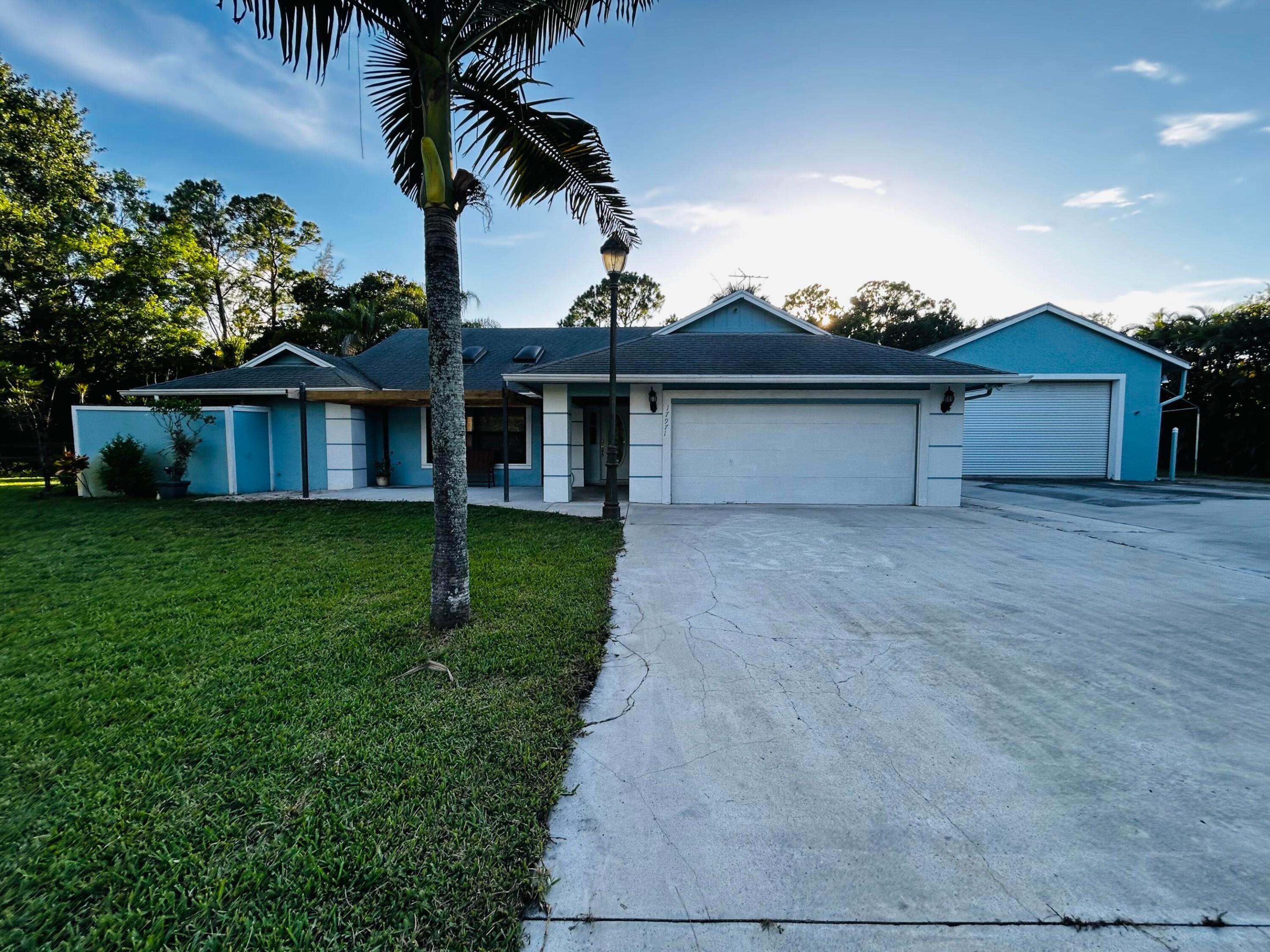 Spacious single-story 3 bedroom 2 bath plus bonus room with pool residence in Jupiter Farms. Two living rooms, covered back porch, screened in pool, separated fenced pasture. The detached five-car garage offers exceptional storage and parking capacity for vehicles, equipment, or hobbies.  Bring your horses, RV, boat, chickens and toys. Just a few minute commute to 95 or turnpike.  Close to restaurants, shopping, beach and more.