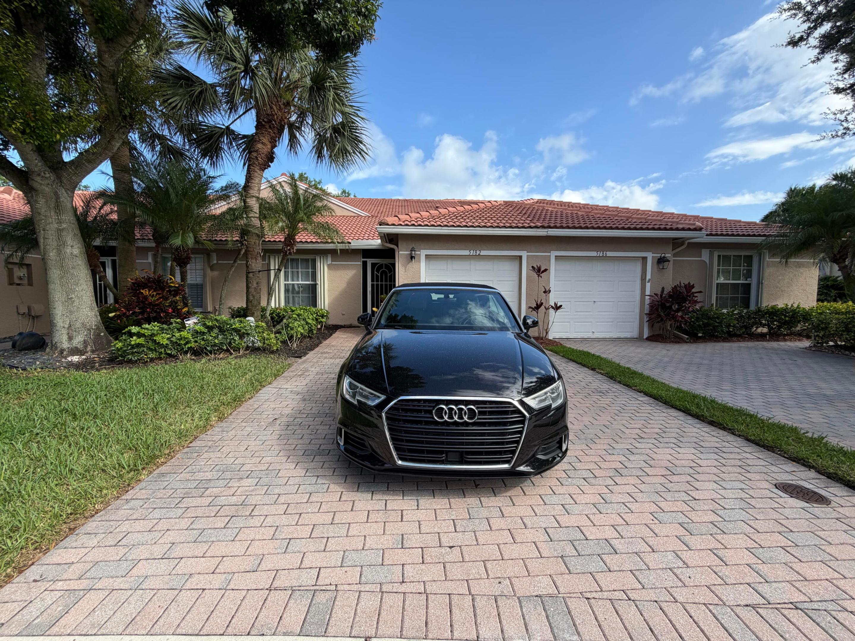Located in the desirable Tuscany Bay community, this charming 2-bedroom, 2-bathroom villa offers the perfect blend of comfort and resort-style living in a premier 55+ gated neighborhood. Built in 2003, this 1,396 sq. ft. home features a 1-car garage, a spacious family room with dining area, a separate living room, and a screened-in patio that serves as your private oasis for relaxing or entertaining. The community is situated within a secure, staffed guard-gated enclave with on-site property management and beautifully maintained tree-lined streets. Residents enjoy a safe, peaceful, and meticulously kept neighborhood surrounded by lush tropical landscaping and sparkling lakes.  Tuscany Bay offers an exceptional selection of amenities, including a expansive clubhouse, fitness center, resort-style swimming pool, library, park, Har-Tru tennis courts, pickleball courts, shuffleboard, bocce court, billiard room, sauna, putting green, and numerous additional recreational and social facilities designed for an active lifestyle. The monthly HOA fee covers internet, cable TV, security, trash service, and comprehensive maintenance of the common areas and grounds—providing outstanding convenience and value. Conveniently located in Boynton Beach, Florida, this home at 5182 Toscana Trail places you near shopping, dining, golf courses, nature preserves, and everything South Florida has to offer, all within a warm and welcoming active adult community.