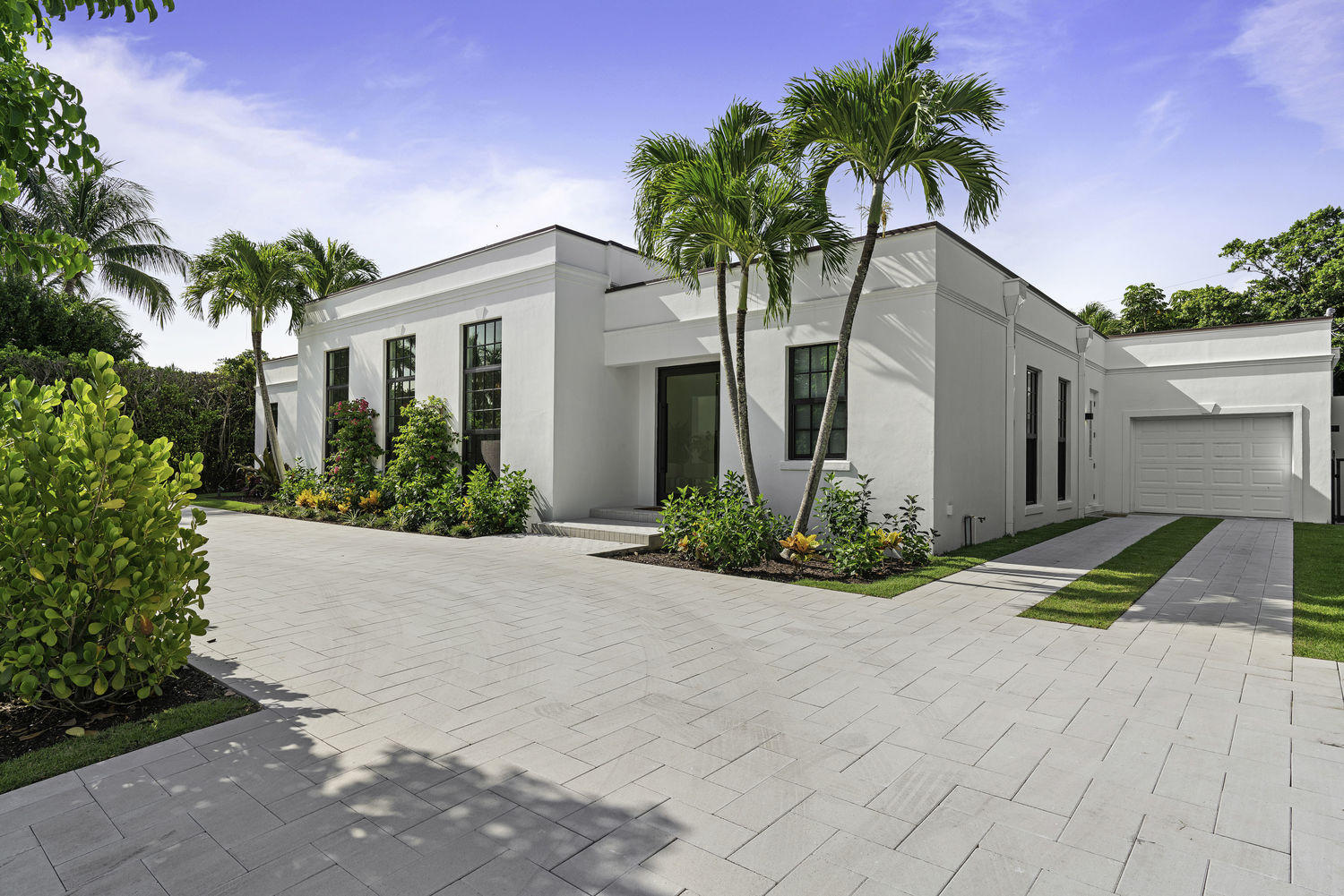240 Sandpiper Drive has been meticulously renovated with the finest contemporary finishes while preserving the grand scale of a classic Gottfried Regency home. The open floor plan and 12' ceilings make for effortless indoor-outdoor entraining. The chef's kitchen is complete with Quartz countertops, Brazilian Quartzite Island, custom cabinetry and Miele appliances. This 4 bedroom, 4 bathroom, and 1 half bathroom residence is expertly crafted with impact windows, a 5-zone A/C system, security cameras, and Wifi allowing convenience at the tap of a button. 

A wall of glass sliding doors lead to a large swimming pool, and patio. 240 Sandpiper is located on one of the most desirable streets in the North End of Palm Beach and comes with deeded beach access.