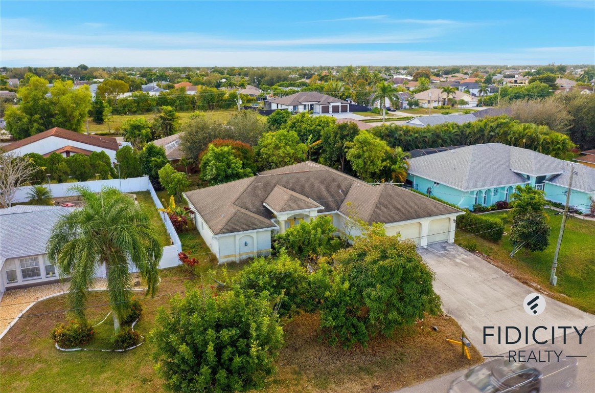 Welcome to this spacious 4-bedroom, 2-bathroom single-family home located in a desirable NE Cape Coral neighborhood. This residence offers a functional split-bedroom floor plan with ample living space, ideal for families, remote work, or entertaining.The home features a bright and open living area, a practical kitchen with plenty of cabinet and counter space, and generously sized bedrooms providing flexibility for guests, office space, or hobbies. The primary suite includes a private bathroom, while three additional bedrooms share a second full bath.Enjoy Florida living with a private backyard, perfect for outdoor relaxation or future customization. Conveniently located near shopping, dining, schools, parks, and major roadways, this property offers both comfort and accessibility.