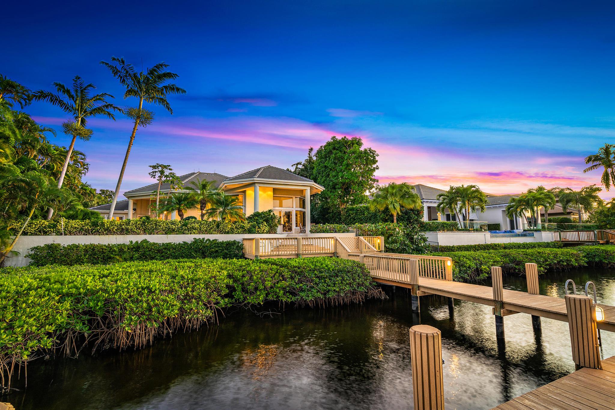 Waterfront Estate Home in desirable Admirals Cove.  This contemporary home boasts large bedrooms, 2 - 2 car garages, NEW ROOF in 2021, granite kitchen, custom cabinets, large office/den with built - in book shelves,  generator, custom ceiling and art niches, over-sized primary suite with separate sitting or exercise room, luxurious bath and doors to the outdoor space.  Relax or entertain around the pool and patio with views of the interior waterways that is within minutes of the Intracoastal. Admirals Cove has 45 holes of golf, pickleball and tennis courts, fully staffed marina, state of the art Spa and Salon - there is never a reason to leave.