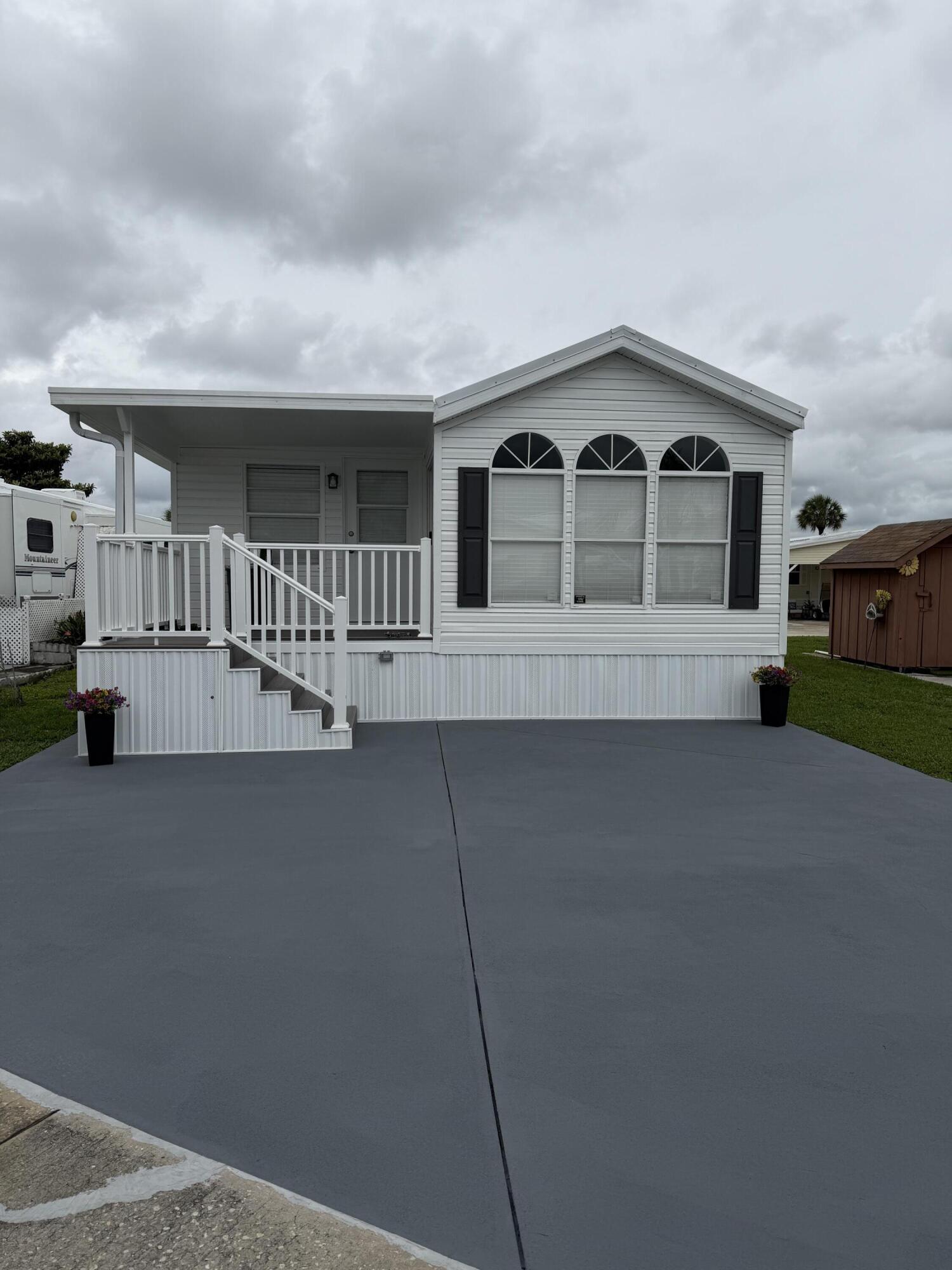 Completely Renovated Gem in Ancient Oaks RV Resort- Lake Okeechobee Fishing Capital! 1995 park model w/addition has been completely renovated from top to bottom and offers 2 Bed 1.5 baths. Move-in ready and tastefully furnished, this home features a modern, open feel with high-end finishes throughout. Enjoy a brand-new kitchen with Marble countertops, new cabinetry, and all-new appliances. Both bathrooms have have been beautifully updated w/smart mirrors, including a walk-in shower. Additional upgrades include new drywall, ceiling fans, light fixtures and blinds. Major system improvements  provide peace of mind, including, New metal roof, new a/c and ductwork, new water heater, all new electric, new tie downs, new vapor barrier. Pet friendly 55+ community. Active lifestyles, clubhouse.