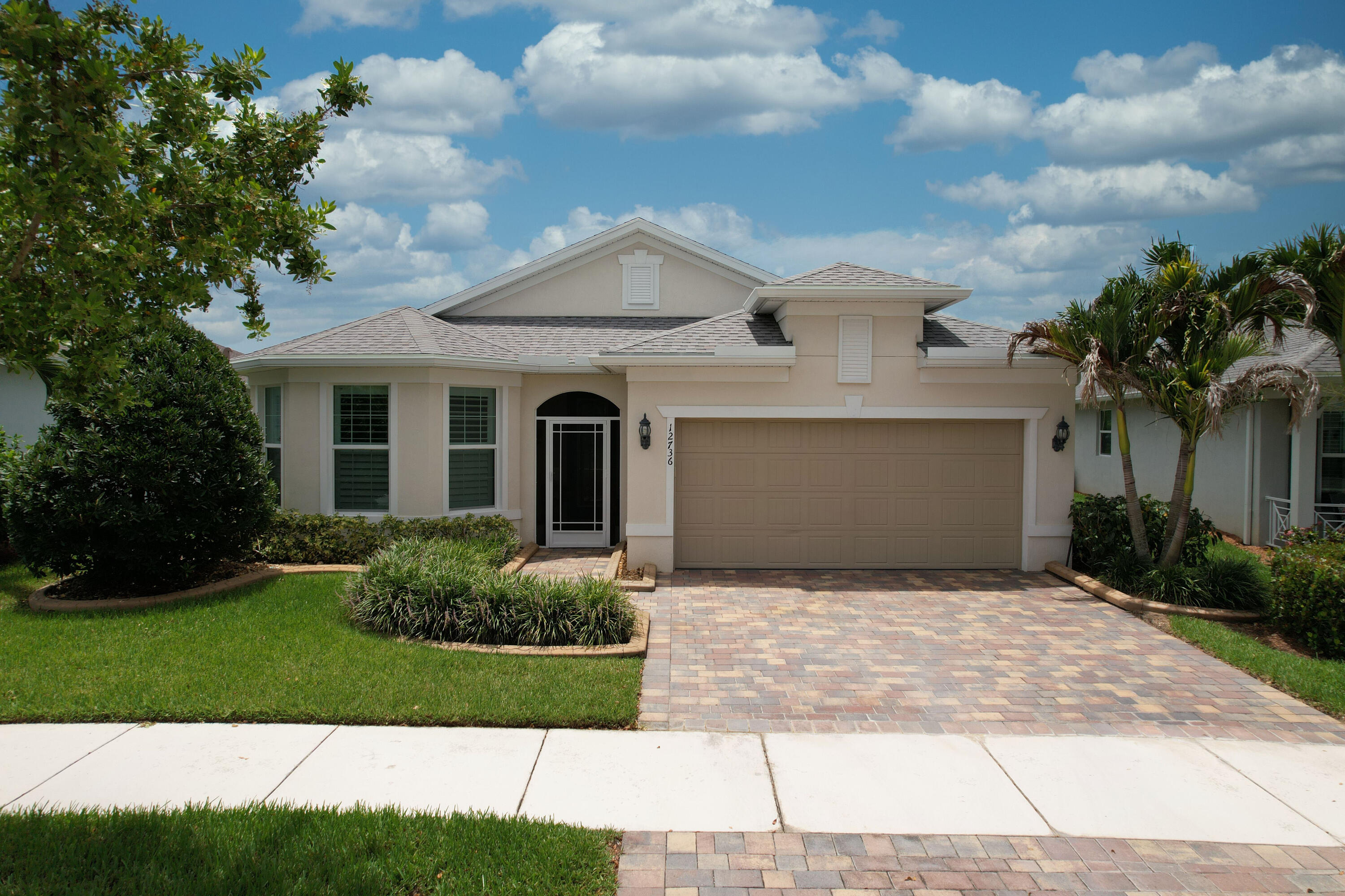 Gorgeous expanded Summerwood model in Del Webb at Tradition, perfectly situated on a peaceful lakefront homesite. This beautifully upgraded home features 2 bedrooms, 2 baths, plus a flex room with French doors, ideal for a home office, den, or guest bedroom. Elegant upgrades include 8-foot interior doorways, tile flooring throughout, crown molding, plantation shutters, and custom drapery. The gourmet kitchen offers quartz countertops, 42-inch cabinets, a large center island, and an open-concept design that's perfect for entertaining. Additional features include impact windows, a tankless water heater and a whole-house generator. Relax and enjoy serene lake views from the expanded covered, screened lanai with retractable electronic screens for year-round outdoor living.  An extended paver patio provides the perfect space for grilling, relaxing, or soaking up the sun by the water. Del Webb is an active 55+ community with 2 clubhouses, 2 pools, pickleball, tennis, bocce, putting green and dog park.