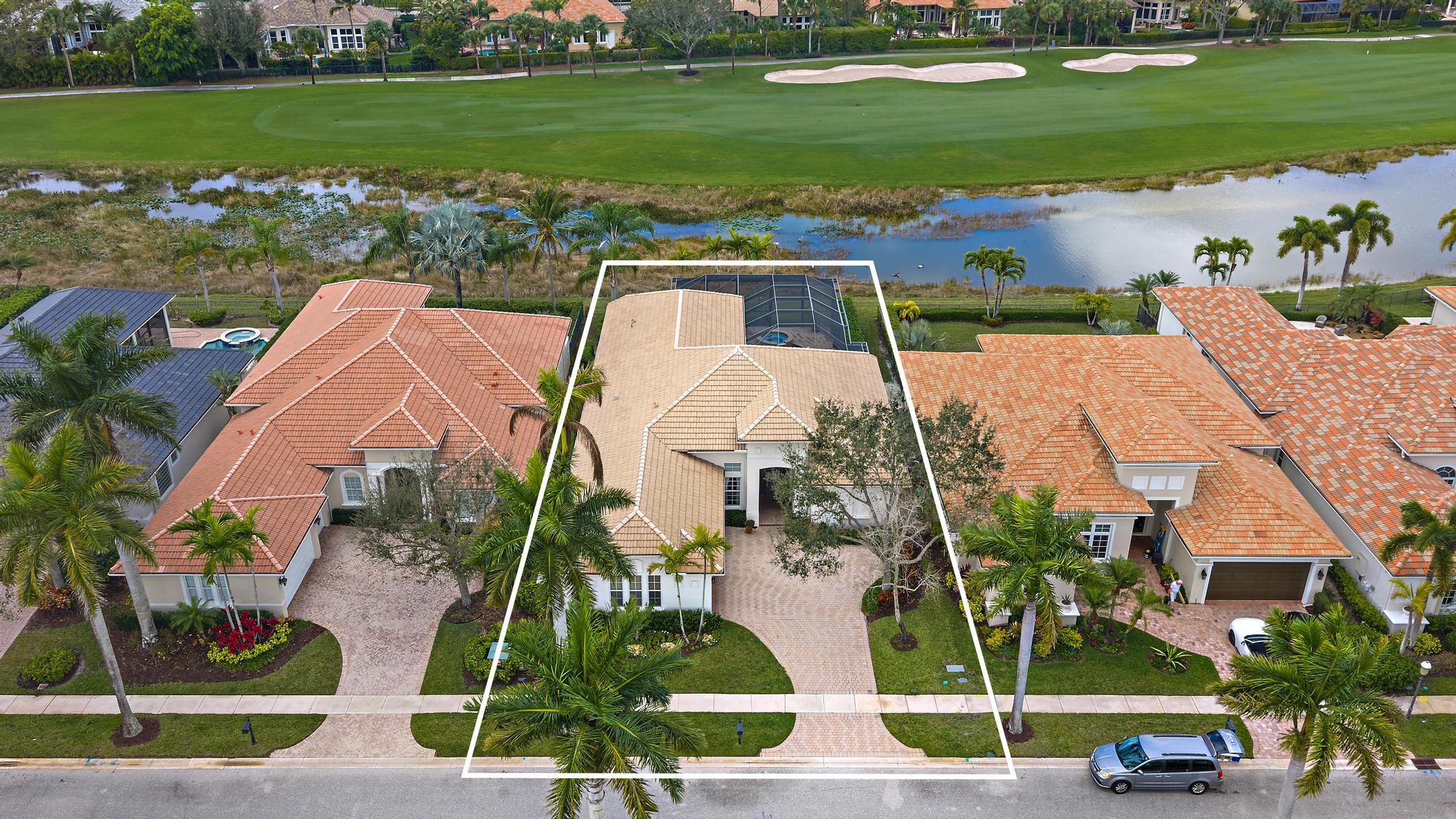 This one-owner residence has been exceptionally well built, thoughtfully upgraded, and meticulously maintained, offering a rare opportunity on a premium west-facing water and golf lot in Isla Vista, overlooking the 10th hole of the Tradition Course. With impact glass across the front elevation, accordion hurricane protection on remaining openings, and a 2025-installed generator, this home delivers both beauty and confidence.  The Engel Homes "Hawthorne" model offers 3 bedrooms, 3 baths, plus a den, enhanced by timeless marble flooring, elevated moldings, tray ceilings, and refined architectural detailing throughout.  The upgraded kitchen is designed for both functionality and style, featuring double ovens, upgraded wood cabinetry with glass display accents, a built-in spice rack, pull-out drawers for pots and pans, uplighting above the cabinetry, and a new stainless refrigerator (2026) and dishwasher (2024).  A custom breakfast banquet with built-in seating and storage overlooks the pool and spa, framed by some of Ibis's most spectacular sunset golf views. The family room impresses with dramatic box-beam ceilings and a custom illuminated wall unit complete with wine storage and pull-out drawers.  The expanded primary suite offers a private sitting area, built-in desk and cabinetry, and a beautifully appointed bath featuring marble flooring, seamless glass shower enclosure, rain shower with seat, and elegant finishes. All bedrooms feature tray ceilings and California Closets. Additional enhancements include a two-zone HVAC system, upgraded lighting package with accent spotlights, and custom linen draperies.  Outdoor living is equally compelling, with a screened pool and spa featuring a 2021 heater, Jandy remote system, enhanced lighting, and autofill. Three sets of sliders open to the expansive enclosure, creating seamless indoor-outdoor living. The landscape irrigation system draws from the lake, offering significant savings in water costs.  Located within the desirable Isla Vista enclave, residents enjoy the exceptional lifestyle of The Club at Ibis, including a 90,000-square-foot clubhouse, three Nicklaus-family championship golf courses, five dining venues, a world-class fitness complex and spa, and premier racquet facilities.