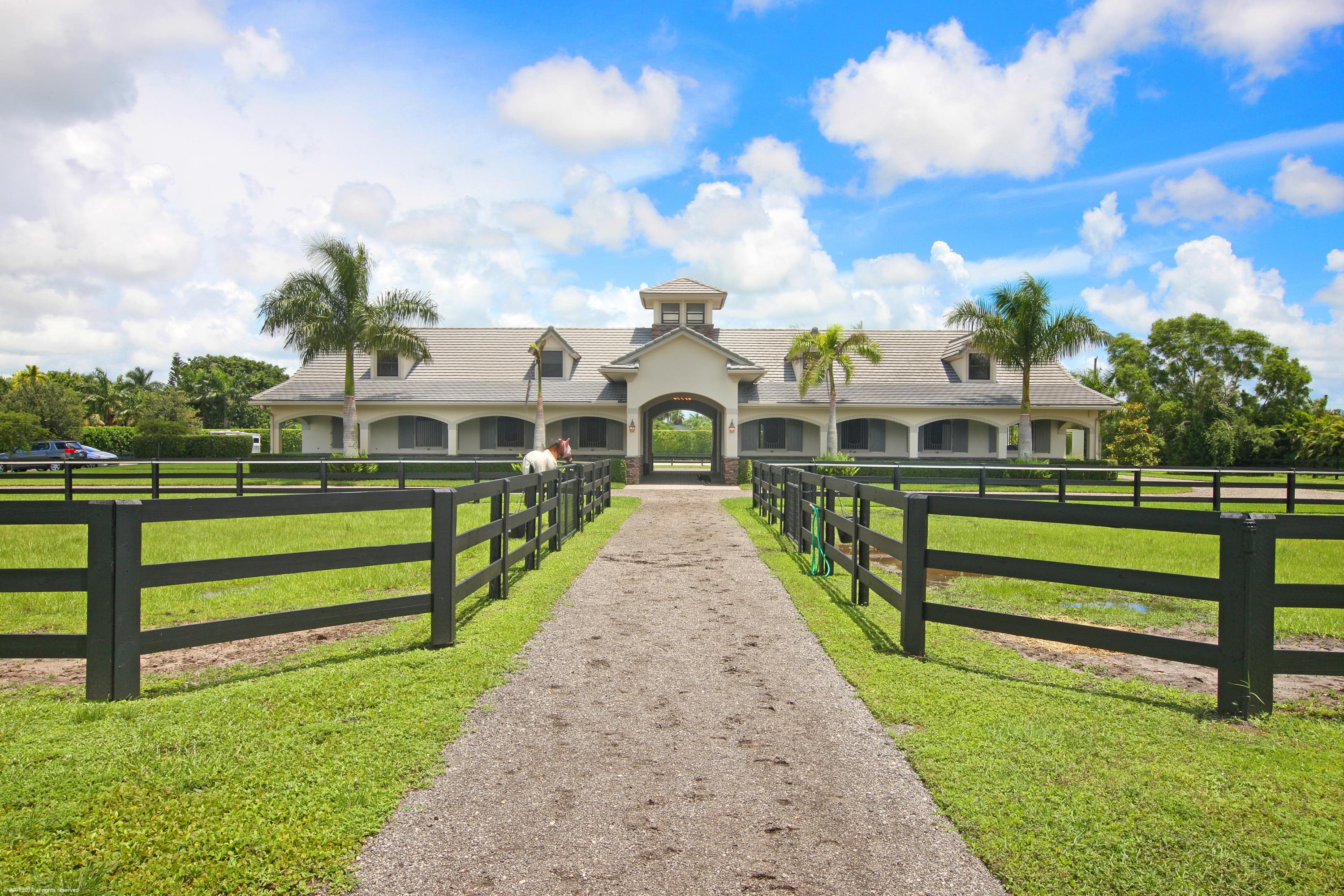 Reduced $800,000 off Orginal List Price!  Prime Location in the front part of Palm Beach Point. 5.68 Acres on the cul de sac & w/ direct bridle path access to Pierson Road, WEF & Grand Prix Village. Center-aisle stable with 8 stalls & 2 wash stalls, plus a 1Br/1Bth staff apartment. Arena w/ new Martin-Collins footing. 6 paddocks & separate barn entrance. The 4Br/4Bth main residence has a heated pool, marble & wood floors & granite finishes. The kitchen boasts an eat-in ctr.-island, professional grade gas range, copper country-style sink & huge walk-in pantry. The Master suite offers views to the stable and a sitting room/office, an over-sized walk-in closet & Jacuzzi tub. Poolside there is a covered patio with summer kitchen and fenced green areas for family pets. Brand New in 2018: Whole house Generator and footing in the riding arena. Arena has mirrors.

The Main Residence:

Marble & Wood Floors

Plantation shutters

Impact windows & doors

Mahogany wood front doors

Master Bedroom with French doors & views to the stable.

Master bathroom with whirlpool tub, dual vanities & bidet

Sound systems in the family room, master & patio

Formal Dining room with serving counter with wine chiller

Central Vacuum throughout

Mudroom entry from garage

 

Reverse osmosis water treatment system supports the house and stable.

Electric pool heater.

Laundry machines are Electrolux (house & stable)

 

Barn & Apartment::

Marble floors, walk-in closet

Kitchen with dishwasher & refrigerator

Alarm system

Fly spray system

Water to each stall

French Doors to the patio

Air-conditioned tack room.

Stall cameras & sound system

Separate satellite at the barn

Attached storage garage

 

Separate gated barn drive entry. Gate at the rear of the property to the bridle path.
Light fixtures in Dining room & Entry fixtures are excluded.