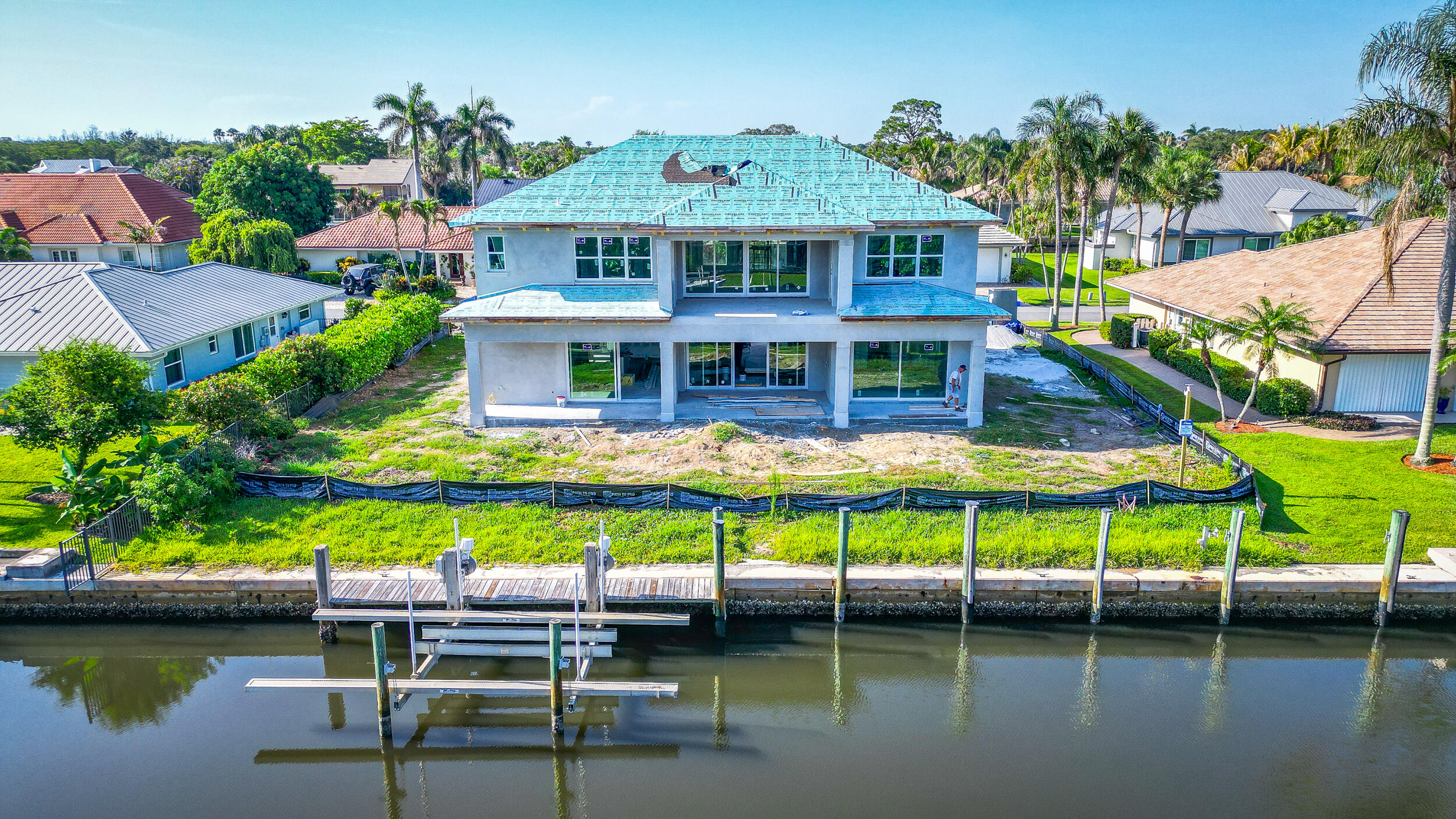 Located in The Soundings, this waterfront residence is currently under construction with an anticipated completion date of late September to early October, presenting a rare opportunity to own a newly built 4-bedroom plus office home in one of Hobe Sound's most desirable boating communities. Situated along the canal and designed around its waterfront setting, the home will offer approximately 3,860 square feet under air, along with a private pool, spa, and spacious outdoor living areas that take full advantage of life on the water.  The open-concept floor plan centers around a large great room, kitchen, and dining area that seamlessly connect to the covered lanai, pool, and spa.  The first-floor primary suite provides privacy and convenience, while the second floor features additional bedrooms, a game room, office, and covered balcony.  Whether you're heading out for a day on the water, entertaining poolside, or simply enjoying the peaceful canal views from your backyard, this home was designed to maximize everything that makes waterfront living so desirable. New construction also provides the advantages of modern building standards, impact glass, and the peace of mind that comes with owning a home built to today's standards.  Residents of The Soundings enjoy a true boating lifestyle with convenient access to the Intracoastal Waterway, nearby sandbars, waterfront restaurants, fishing, and nearby beaches. New construction opportunities in Hobe Sound are limited, and newly built waterfront homes are even rarer. Combining the benefits of waterfront living with the advantages of new construction, this is a unique opportunity to own a brand-new waterfront home in a location where opportunities like this seldom become available.