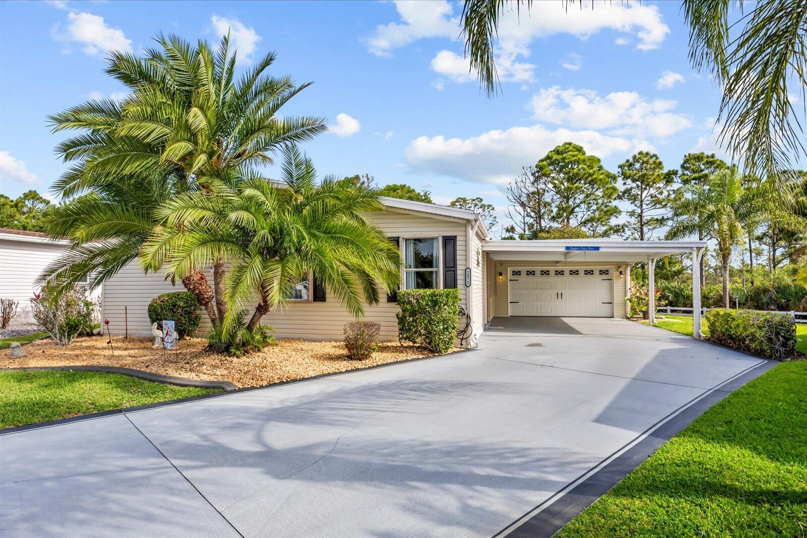 Florida living at its finest in this fully updated Presidents Choice model located in the desirable Savanna Club 55+ community. This spacious 3-BR, 2BA split floor plan offers privacy and comfort while backing to the scenic Savannas Preserve for peaceful nature views. The remodeled kitchen features granite countertops, SS appliances, and abundant cabinetry. Updated bathrooms, laminate and tile flooring thru/out, acc. shutters, a 2019 roof, and a 2025 A/C provide modern style and peace of mind. Relax year-round in the tiled 31' lanai or entertain on the open patio with pergola. Additional highlights include a cost-saving irrigation well, decorative double driveway, carport, and oversized 2-car garage. Land Lease Property