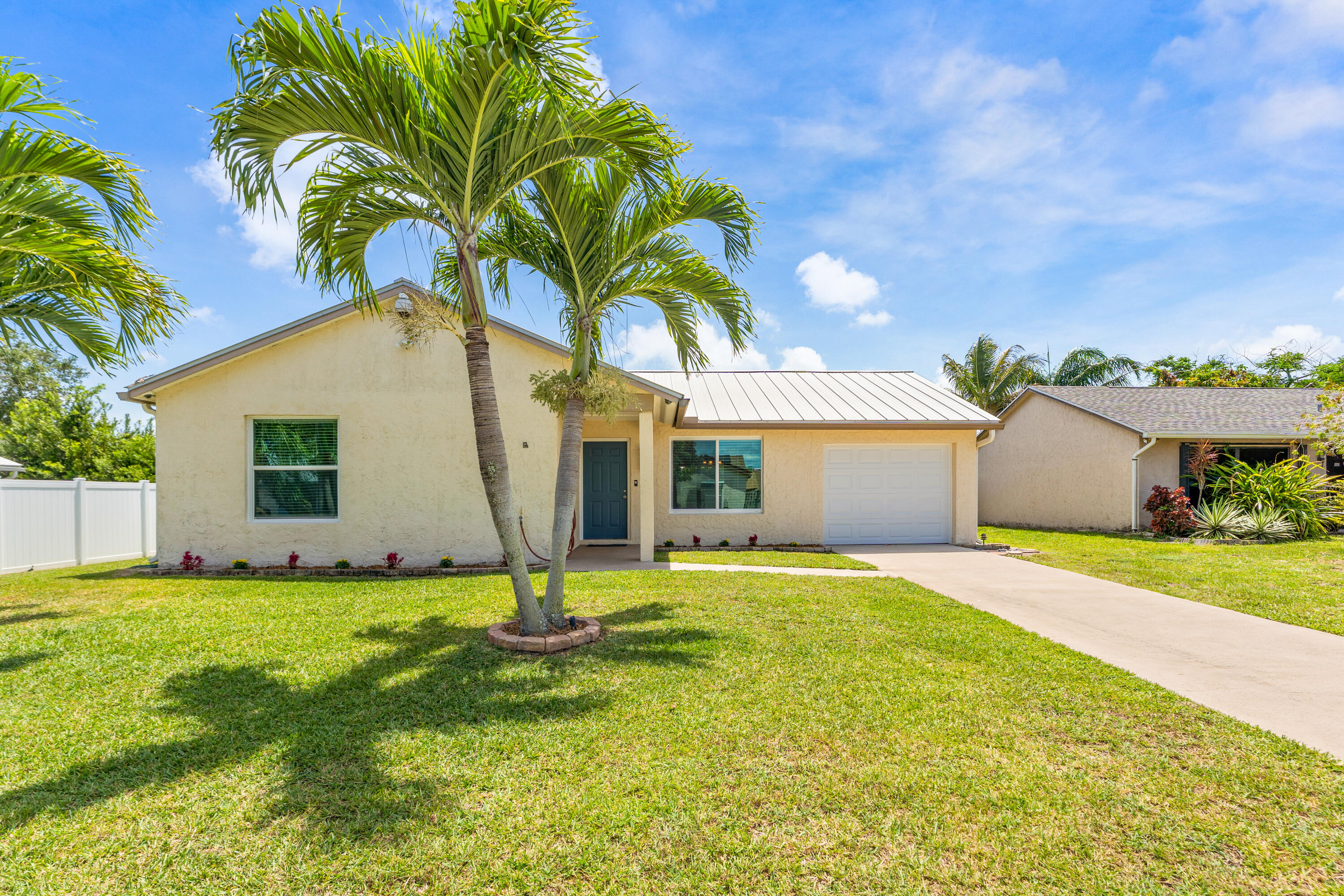 LOCATION  LOCATION  LOCATION!!! Welcome to 105 Banyan Circle in Jupiter Village. This 3-bedroom, 2-bath home with a 1-car garage is situated on a large, private corner lot. The metal Roof was replaced in 2018 and has 2 years remaining on warranty. Water Heater was installed in May 2026 and the owner is in the process of installing new air conditioner. Lastly, this home comes with impact resistant windows and slider. Located in a family-friendly neighborhood, the property offers a peaceful setting and is within walking distance to multiple parks and the community pool. Enjoy close proximity to I95 and Turnpike, Jupiter's beaches, golf courses, shopping, and dining. Offering the perfect balance of privacy, convenience, and lifestyle.