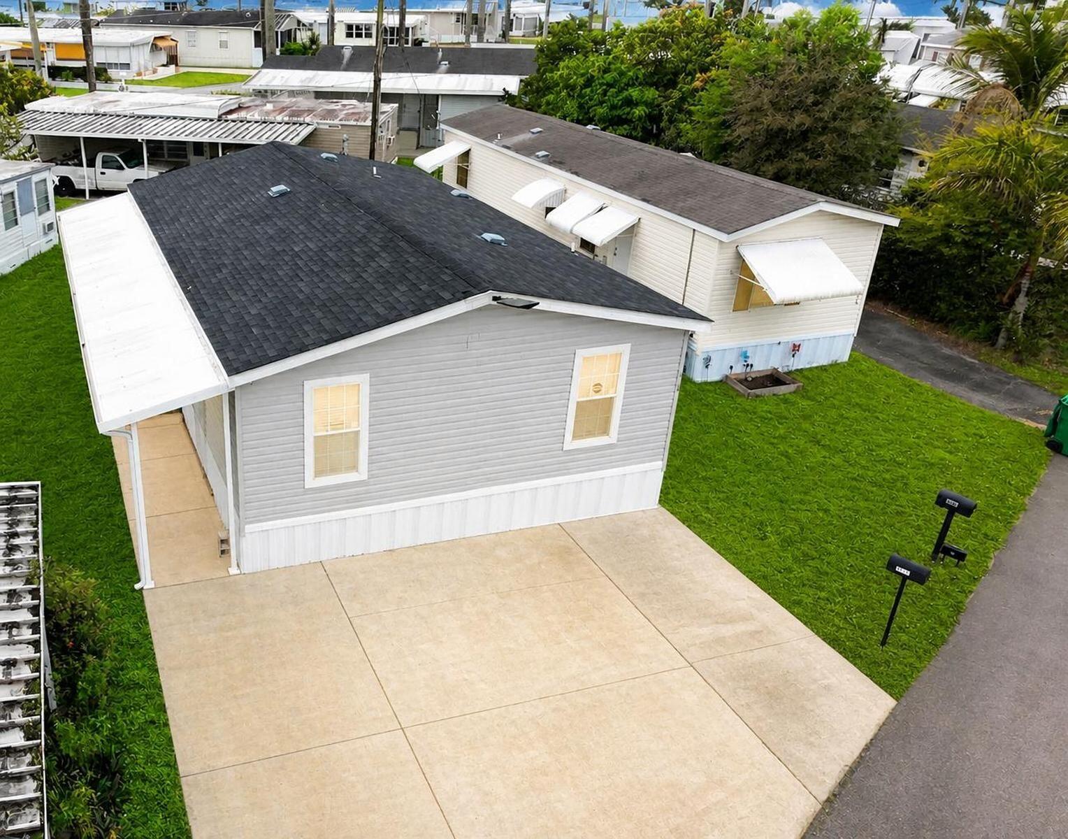 Manufactured home located in the desirable city of Davie, with land ownership included (owner owns the land). Built in 2023, this well-appointed 3-bedroom, 2-bath residence features a dedicated laundry room. The home is filled with abundant natural light, enhanced by multiple windows throughout, and showcases a modern open kitchen. The property offers ample parking for up to five vehicles. Community requirement: at least one occupant must be 55+. Seller contribution of $10,000 for the Buyer! OWN THE LAND!!   LOW HOA FEE OF ONLY $77 PER MONTH