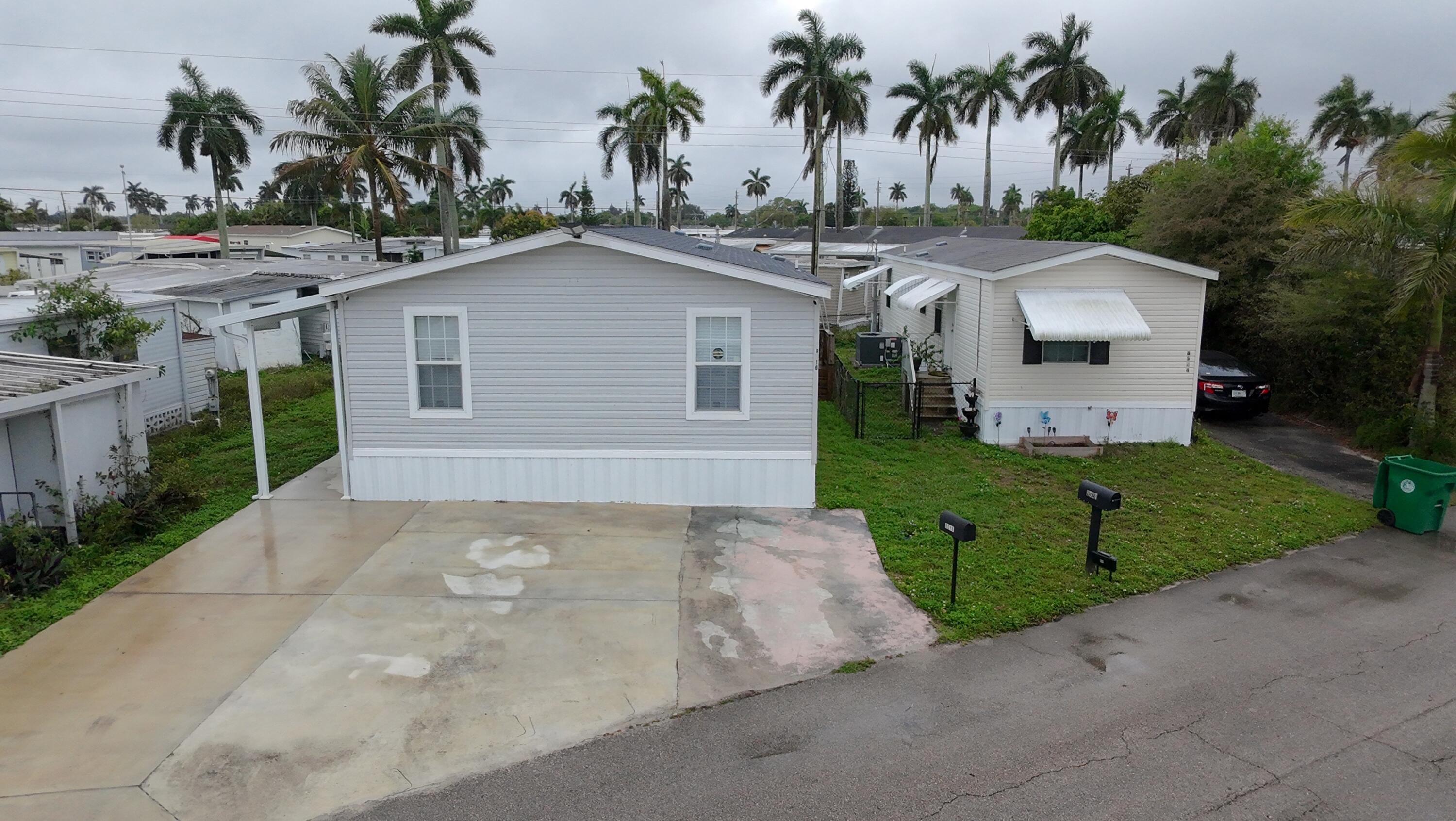 Manufactured home located in the desirable city of Davie, with land ownership included (owner owns the land). Built in 2023, this well-appointed 3-bedroom, 2-bath residence features a dedicated laundry room. The home is filled with abundant natural light, enhanced by multiple windows throughout, and showcases a modern open kitchen. The property offers ample parking for up to five vehicles. Community requirement: at least one occupant must be 55+. Seller contribution of $10,000 for the Buyer! OWN THE LAND!!   LOW HOA FEE OF ONLY $77 PER MONTH