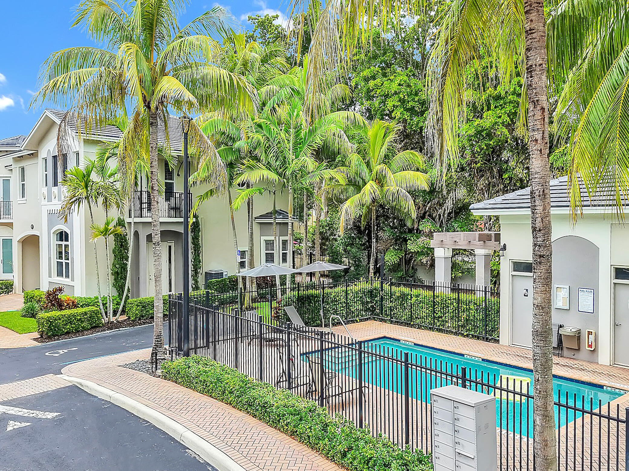 Sought-after corner/end-unit townhome with an enviable location just steps from the community pool. This spacious 4 bed/4 bath residence offers 2,722sf of beautifully appointed open-kitchen living space with hardwood floors, granite countertops, crown molding, plantation shutters, impact windows, vaulted ceilings, and a new roof. The home's desirable split-bedroom layout ensures privacy and includes a luxurious primary suite with two walk-in closets. Two of the three additional bedrooms also feature their own en-suite bathrooms. A versatile bonus space off the hall provides the perfect spot for a home office or study nook. Enjoy your expansive paver patio offering direct access to the pool and street, perfect for an impromptu barbecue or gathering.  Tucked inside a small, pet-friendly gated community with added privacy and security, it sits right by the newly redesigned Old Germantown Road, where you can walk under the shade of mature trees. All of this is just minutes from I-95, Whole Foods, Costco, fine dining, shopping, the Delray Beach Art District, and the beach. A move-in ready hidden oasis in South Delray Beach. Easy to tour or show.