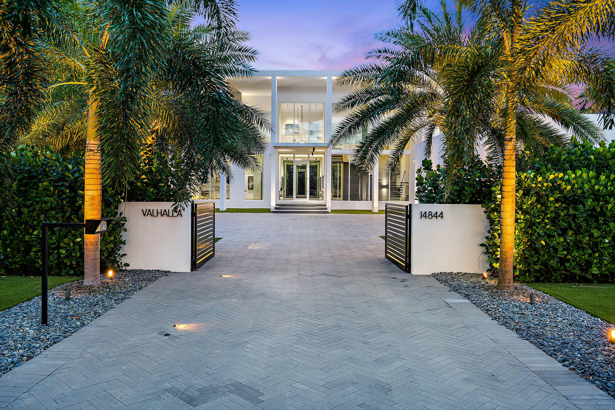 Newly constructed in 2018, this home exquisitely defines the new 'International style classic' in architecture - rarely available and highly coveted. Celebrating pure residential art and offering laser precision perfection on every level -  a private gated drive opens to expanded herringbone stone motor court. Visually striking inside + out, this home is designed w/ no expense spared to create a living experience that embodies luxury, wellness + serenity.  A rare opportunity, this home is offered Fully (turnkey) furnished and is Move in Ready. Sited along 100' of Intracoastal waterfront w/ new seawall, double dock/deck + pristine landscaping.  Glamorous living with two story glass atrium foyer and sleek floor to ceiling windows creating a dramatic indoor/outdoor connection.  Interiors are awash with sunlight and neutral hues, artfully showcasing the iconic attention to detail: 1 X 1 metre stone flooring imported from Italy, Rimadesio pivot doors, custom Boffi cabinetry+ fixtures and circadian rhythm lighting.  Fully integrated audio/visual smart technology.  Main living areas offer VIEWS, scale + comfort.  Bespoke kitchen with adjacent glass wine room, Gaggenau and Miele appliances is a minimalists dream.  Elegant dual master bedrooms, upstairs + down, bring luxury to a whole new level with floor to ceiling doors opening to expansive shaded patios...Ocean breezes + water views!  Upper Master suite includes a sitting area and morning kitchen.   Interior furnishings are custom B & B, Living Divani and Talenti, imported from Italy.  Form meets highest end function in every detail including a 60KW Generator, 21 Seer A/C units, Outdoor summer kitchen with fire pit.   Saving the best for last, this home raises outdoor living to a new level of beauty + enjoyment w/ terraced water features, a lavish 51' X 36' waterfront pool, sundecks, and generous green space w/ serene lighting.  Close to PB International airport, world class shopping, dining, educational, golf, sport + cultural venues.  Palm Beach Gardens offers a low density lifestyle and No State income tax!   A beautiful lifestyle awaits you...