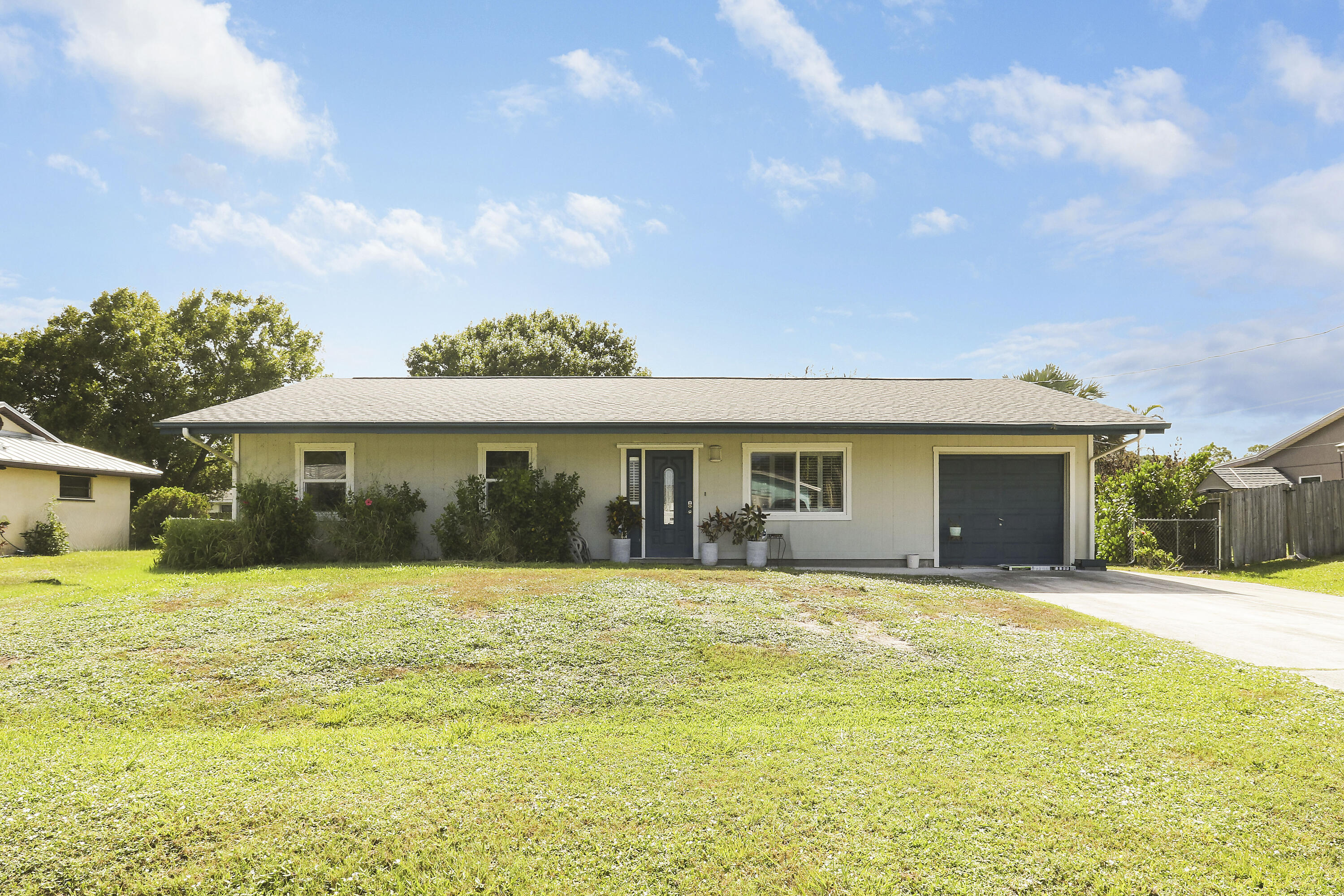 4 bedroom, 2 bath home in the sought-after Indian River Estates. Fully tiled throughout with laminate wood in one bedroom . Huge screened and covered patio with wood like tile flooring, great for outdoor entertaining. Garage converted to 4th bedroom but can easily be changed back. All windows were replaced in June of 2023, with planation shutters throughout the home. AC replaced in 2023 with 10-year transferrable warranty. Roof redone in April of 2023.