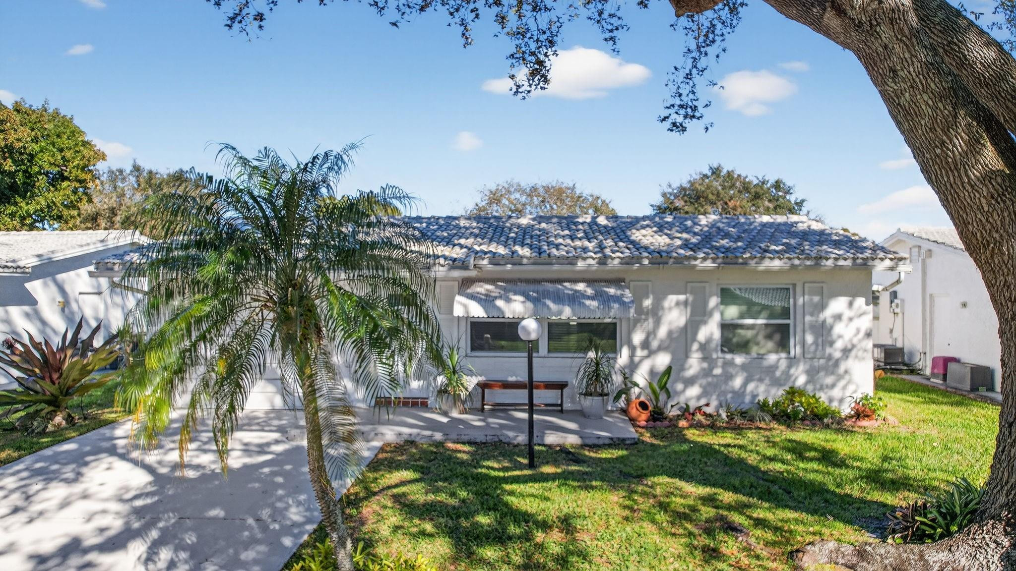 Welcome to Lauderdale West an Active ADULT community in Central Plantation.  This Home is move in ready and recently updated with new flooring, new bathroom, new kitchen and appliances.  Screened in patio for the outdoor lover.  Driveway will fit 2 vehicles.  1 car garage with full size washer and dryer.  This home is equipped with an electric vehicle charging station.  Tons of amenities are available in Lauderdale West for you to enjoy.  Pool, billiards, tennis, crafts, ping pong, clubhouse and more!  Don't drive,  Don't worry.  Lauderdale West has a community bus to take you to the Publix and other nearby shops.  Lauderdale West is a NO pet community.  Walk to Publix, Walmart neighborhood grocery and more!  IMPACT WINDOWS make this home hurricane ready.