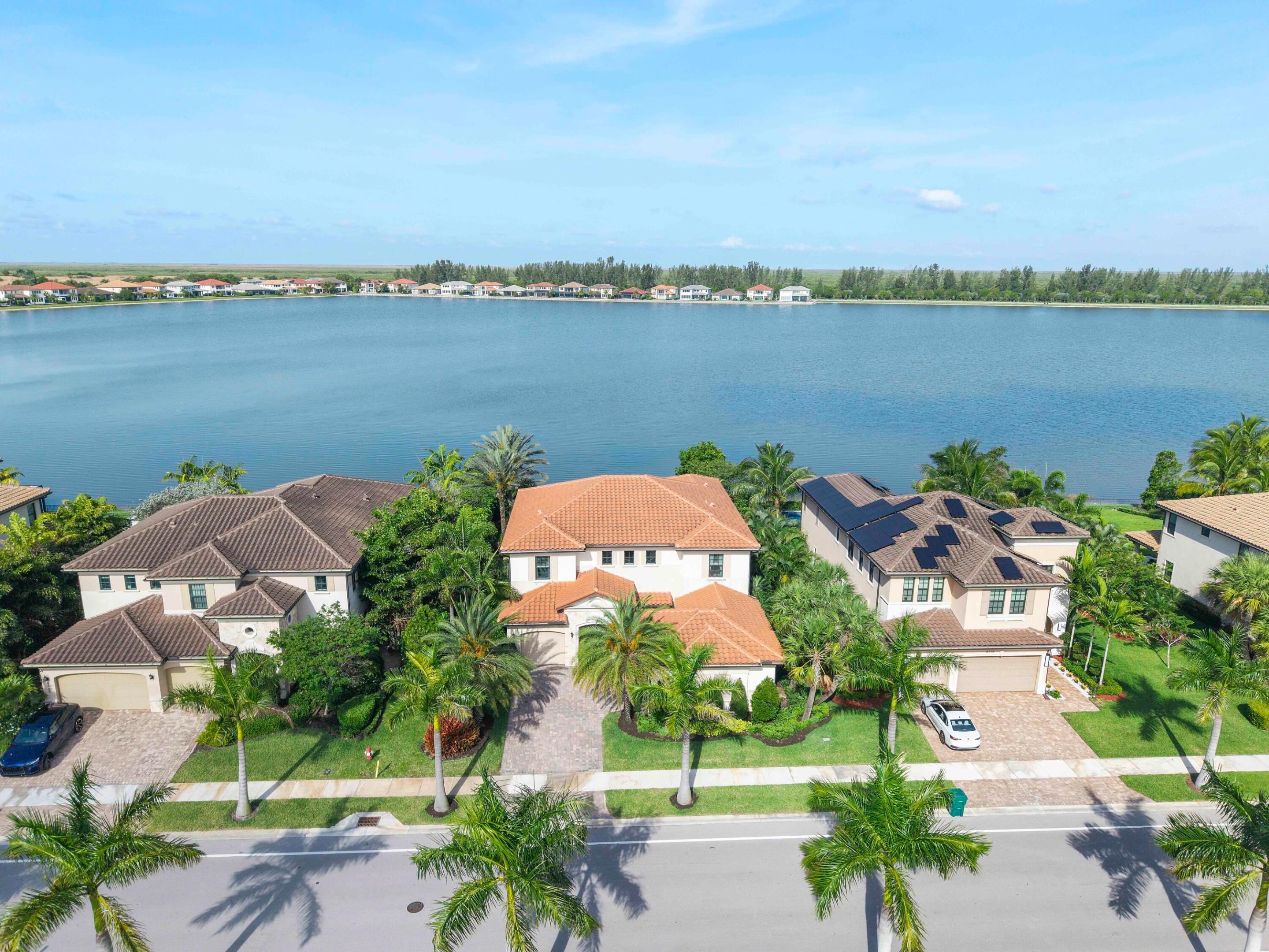 Welcome to this breathtaking dual lakefront model home in Parkland's premier community, showcasing stunning views of a tranquil 178-acre lake. This exceptional property features 5 spacious bedrooms, 5 bathrooms, and two dedicated offices, all within 3,959 square feet of luxurious living space, complemented by a private pool and a 3-car garage. The open floorplan effortlessly connects a formal dining room, an expansive family room, and a gourmet kitchen, flowing into an oversized covered terrace perfect for entertaining. A convenient first-floor bedroom is ideal for guests, while four additional bedrooms on the second floor ensure ample space for family. Enhanced with designer touches like volume ceilings, elegant accent walls, and custom window treatments, this home is a true masterpiece.