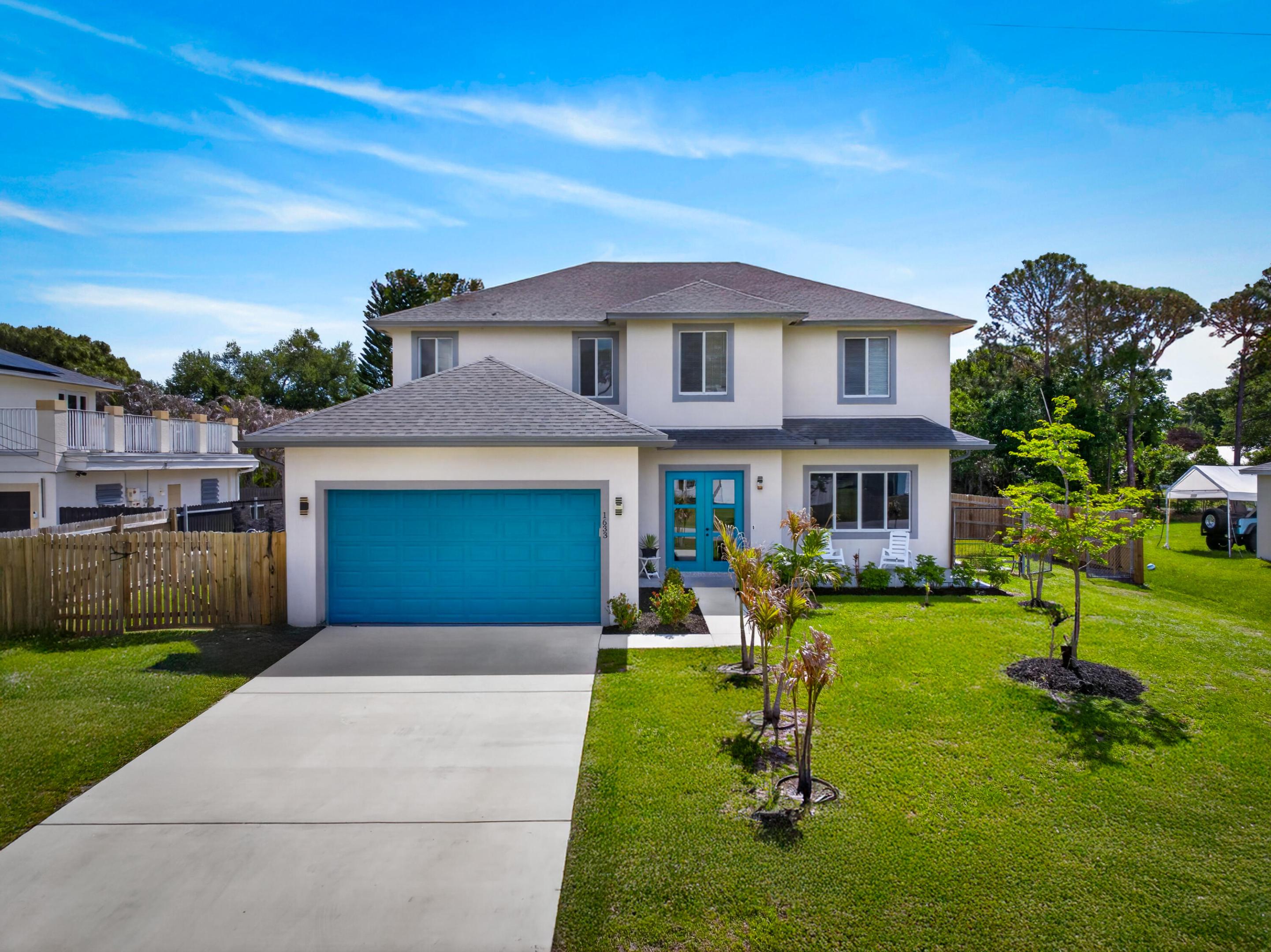 Welcome to this stunning 2024-built two-story home in the heart of Port St. Lucie! This move-in ready residence offers 5 bedrooms and 3.5 bathrooms, providing the perfect blend of space and comfort. The beautifully designed kitchen is the centerpiece, featuring sleek quartz countertops, striking two-toned cabinetry, and a large island ideal for entertaining and everyday living. The open layout flows seamlessly into the main living areas, filled with natural light and modern finishes throughout. Built with full impact windows and doors, this home offers enhanced security, storm protection, and energy efficiency. Conveniently located near shopping, dining, schools, and major roadways—skip the builder wait and move right in!