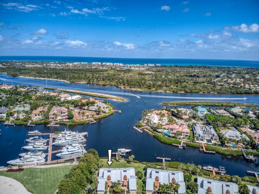 The only attached villa in Admirals Cove with spectacular views of the Intracoastal. Approx 3000 sqft under air, impact glass sliding doors in the entire living area, one story, only 15 feet to the marina and clubhouse. Sellers enclosed and air conditioned the screened in area and added a room which can be used as a 3rd bedroom. One of a kind, views of the water are breathtaking as you enter.