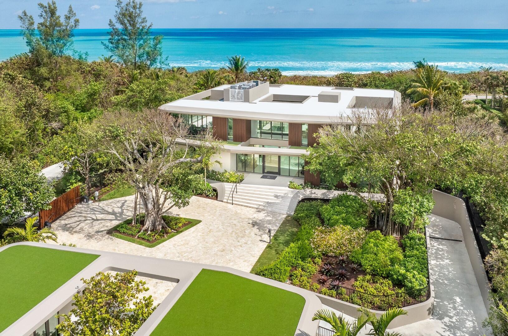 A One-Of-A-Kind and unseen oceanfront estate on Jupiter Island. Designed by internationally renowned architecture firm DOMO Architecture + Design, this breathtaking home four years in the making was inspired by the natural beauty of the blowing rocks of Jupiter Island with organically shaped modern design that reflects the surrounding natural environment. Situated on a sprawling 3.5 +/- acre east and west parcel lot with approximately 179 feet of direct ocean frontage. Painstaking details with 18,500+/- total square feet, the home features 6 bedrooms, 8 bathrooms, and 1 powder room, soaring 11' ceilings on the main floor, and grand double height 24' foyer. Gourmet chef's kitchen with Subzero appliances and oversized eat-in exhibition kitchen with double islands and breakfast area. Light filled living room with fireplace opens to covered loggia. Entertainment area with wet bar. Formal dining room with sliding glass doors on both sides that allow for an "al-fresco" dining experience. Covered dining loggia with summer kitchen. Additional interior features include all glass enclosed 1,300 bottle walk-in wine cellar, second floor family room, large commercial elevator to service all three floors, and laundry rooms on the first and second floors. Gorgeous primary suite with sweeping ocean views, breathtaking oceanfront balcony, midnight kitchen, and dual walk-in closets. Primary bathroom with Italian Carrara marble, dual sinks, free standing oversized soaking tub, and large steam sauna and shower. First floor VIP guest suite with separate sitting room. Second building functions as an incredible wellness pavilion with large, full-scale gym, yoga studio, beauty salon with hair station, wet and dry sauna, shower, massage room, and painting studio that doubles as a separate office. Oversized 50,000 gallon, resort style pool area which features an infinity edge main pool, 60' lap pool that wraps around the main building, and jacuzzi. Beautifully landscaped grounds with hard court championship tennis court with Miami Open specifications and dimensions and large entertainment lawn perfect for soccer and other outdoor activities. 5,000+ square foot airconditioned garage with ample storage and parking for 10+/- cars. Additional 6-car service parking and service entry on the West side of the property. The west side of the property also features a beautiful forested natural reserve area which allows for an additional building or guest house. This is your once in a lifetime opportunity to own a legacy property for generations to come.