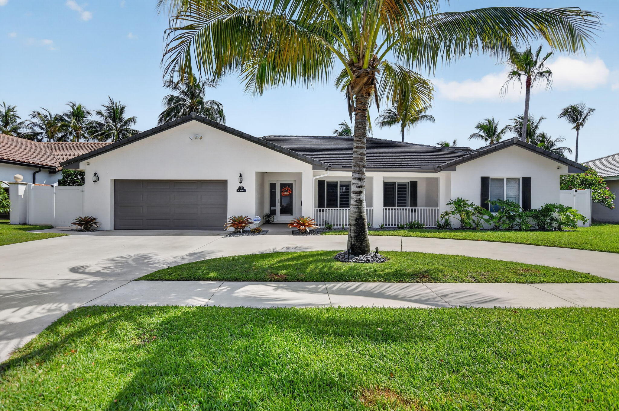 Welcome home to Carriage Hill, one of East Boca Raton's most desirable neighborhoods, known for its mature trees, spacious homesites, and unbeatable location close to everything Boca has to offer. This beautifully updated 5-bedroom, 3.5-bath residence offers over 2,700 square feet of thoughtfully designed living space and a backyard that feels like a private retreat. Enjoy South Florida living at its finest with a saltwater, heated pool, stunning travertine marble patio, tiki hut, turf backyard, and fenced yard—perfect for relaxing and entertaining year-round. Inside, open living spaces enhanced by smooth ceilings, crown molding, plantation shutters, recessed LED lighting, and numerous updates throughout. See More...   The spacious kitchen features a large island, granite countertops, white cabinetry including a wine cooler. The primary suite offers custom closets and a beautifully updated bath with dual vanities, a walk-in shower, and soaking tub. Additional features include full impact glass windows and sliders, hurricane-rated doors, a 2015 tile roof, 2019 high-efficiency A/C with updated ductwork, whole-house water filtration system, finished air-conditioned garage and a large outdoor storage.  Located just minutes from downtown Boca Raton, beaches, shopping, dining, and within the highly sought-after Addison Mizner, Boca Middle, and Boca High School district. Conveniently located near El Rio Park, offering recreation and outdoor activities just moments from your doorstep.