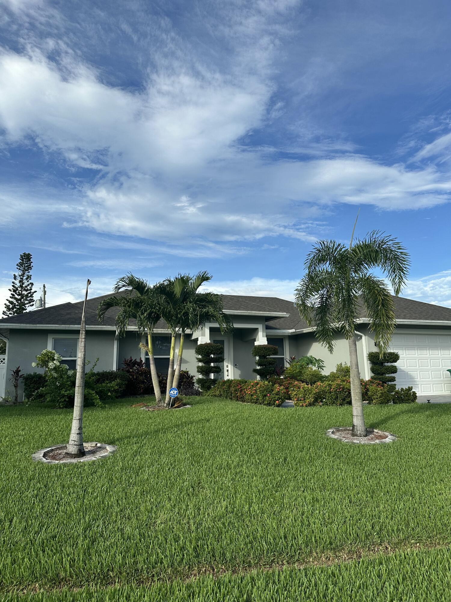 Beautifully upgraded 4BR/3BA in the Becker area, built in 2022 on an oversized lot with no HOA. This move-in ready home offers impact windows, large porcelain tile throughout, and a stunning kitchen with quartz waterfall countertops. Inside you'll find custom-built pantry and closet shelving, plantation shutters on every window with a motorized shade on the slider, and a full-house water purification system plus a separate drinking/cooking filter. The home's electrical panel is generator-ready for peace of mind. Outdoors is just as impressive with a dug well and irrigation system, lush upgraded lawn, 6-ft white privacy fence, and a tropical retreat filled with mature fruit trees--mango, guava, avocado, June plum, and bananas to name a few. Conveniently close to I-95, shopping & beaches.