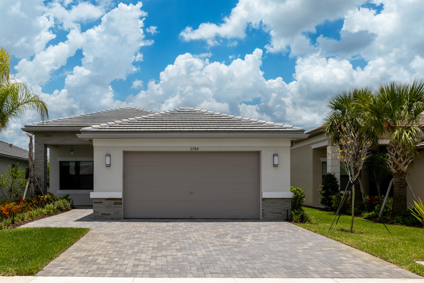 An exquisite blend of superb lifestyle and comfort, this 3 bedroom PLUS DEN, 2.5 bathroom, 2024-built home shows like a model and features an extensive list of over $70,000 in upgrades. The interior is finished with 9' ceiling, recessed lights and stunning LVP flooring throughout. An open-concept kitchen offers upgraded layout with Level IV cabinetry with under and over-cabinet lighting, cabinet pantry conversion, GE Profile appliances, exterior-vented microwave, and convection/air-fry range. Primary suite features gorgeous lake view and TWO walk-in closets with Closetmaid Selectives towers. An en-suite bathroom is finished with upgraded bath cabinetry, built-in linen storage, Roman tub, ceiling-height mirrors, framed mirror detail, Kohler fixtures, pocket doors, and tile extended to the  ceiling. There is a laundry room with a full size washer and dryer, upgraded cabinetry and a sink. Relax on your screened-in patio with a partial lake view. Exterior and everyday-living upgrades include impact windows and doors, upgraded 5-phase HVAC with dehumidifyer, R-30 insulation, added recessed lighting, vapor lights, cable/data outlets, upgraded electrical switching, widened driveway/walkway, extended rear pavers, motion security lighting, garage sink, and polyaspartic garage floor coating. Valencia Walk is a phenomenal, active 55+ community with world-class amenities including clubhouses, indoor and outdoor pools, cabanas, state of the art fitness centers, tennis, bocce, pickle ball, basketball courts, restaurants, cafe, social hall, cards rooms, pro shop, park and a dog park, and many schedules classes and activities. It is minutes from I-95 and conveniently located near grocery stores, shopping and dining. All measurements are approximate. Take a look at the 3D virtual walkthrough today.