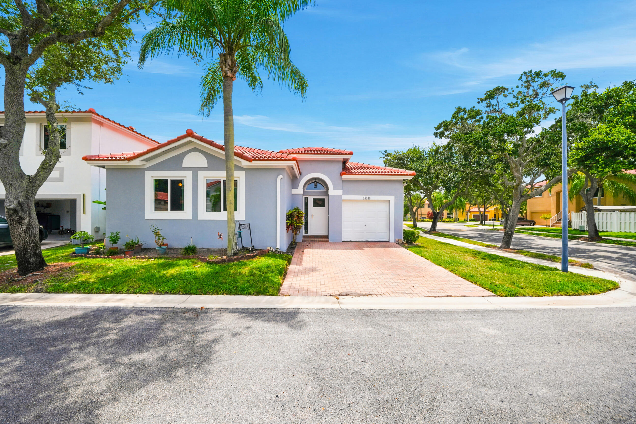 MOVE-IN READY in one of Weston's most desirable gated communities! Situated on a premium corner lot, this beautifully updated home offers peace of mind with a BRAND NEW tile roof, NEW IMPACT windows & doors, NEW HVAC, and NEW spacious kitchen. Soaring vaulted ceilings and abundant natural light create an open, airy feel, while the split floor plan provides privacy and functionality. The renovated kitchen features a smart touchless faucet, updated appliances, and flows seamlessly into the main living areas. Enjoy year-round indoor/outdoor living with a screened porch overlooking the fully fenced backyard. The spacious primary suite features dual vanities, a soaking tub, and a walk-in closet. Community pool, A+ schools, and an unbeatable Weston location!