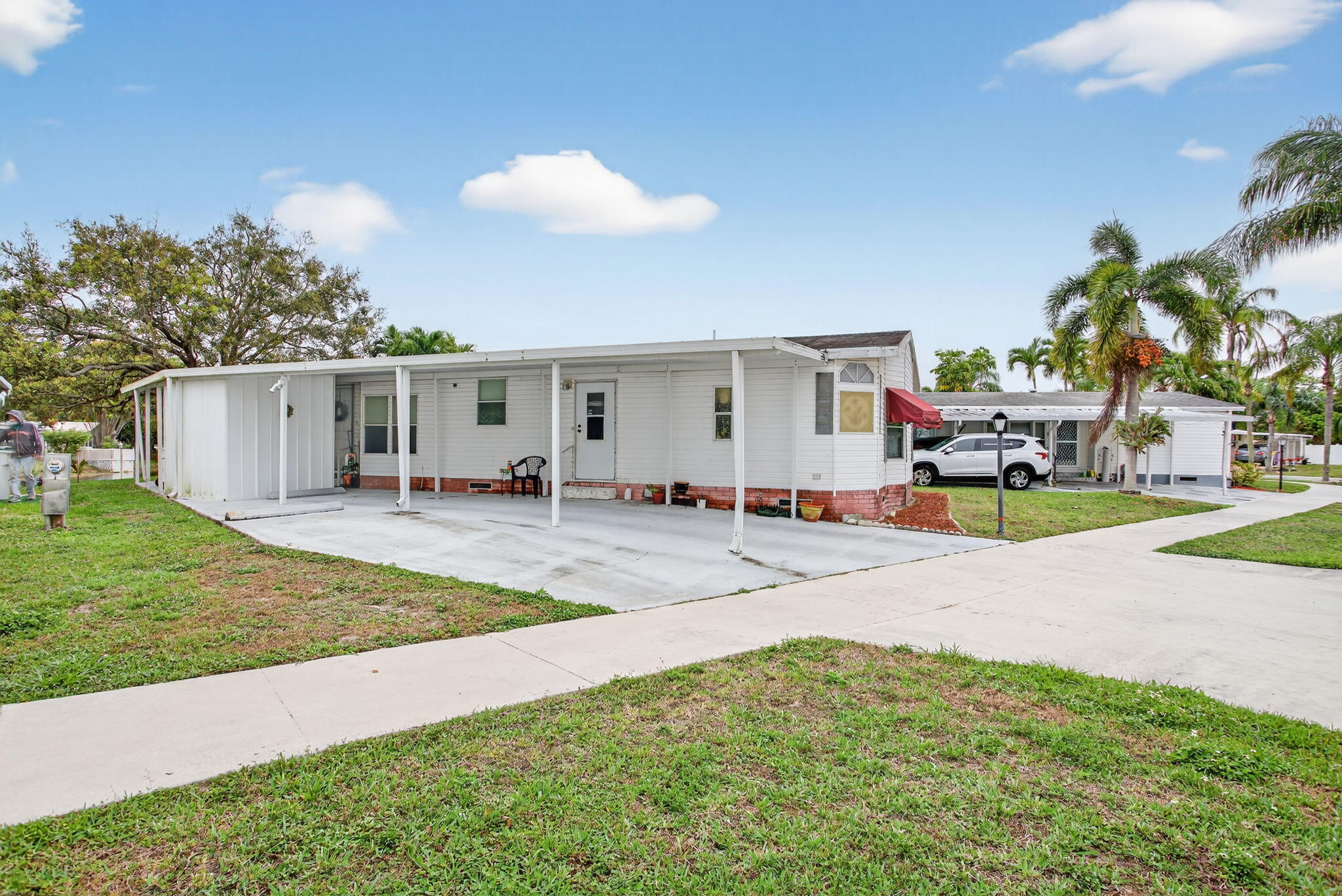 You own the land! 3/2 Manufactured home located in Tallowwood Isles one of the best and cleanest 55+ mobile / manufactured home communities in South Florida! This large home (1,614 sqft) sits on a small lake with water views. The home was built in 1992 and is clean and in good shape. Tallanwood Isles is centrally located and just a short drive to the famous Deerfield Beach as well as Boca Raton with easy access to the Sawgrass, Turnpike and I-95.  This home features a split bedroom plan and has a large kitchen and dining area. Driveway holds four cars two under the carport and the home also has a carport storage area. Large screened patio over looks the lake and is prefect for entertaining or just relaxing. The community is pet and golf cart friendly!