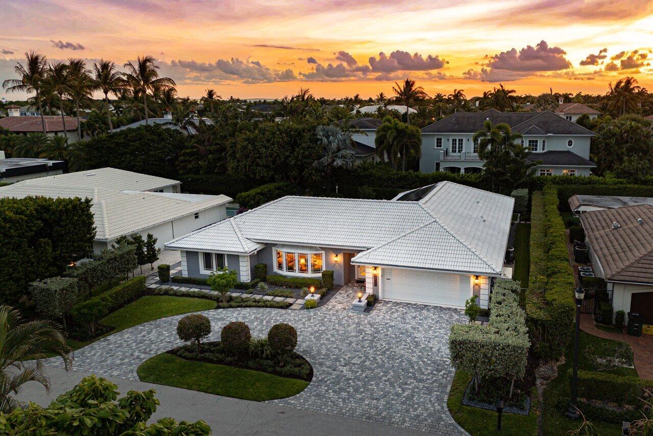 Experience refined, effortless living in this stunning one-story residence, ideally situated within the prestigious Royal Palm Yacht & Country Club. Thoughtfully renovated, this exceptional home showcases a spacious split-bedroom floor plan with four bedrooms and three full baths, designed for both comfort and privacy. A gracious formal living and dining area sets the tone upon entry, while the separate family room provides a warm, inviting space for everyday living and entertaining. The chef's kitchen is a true centerpiece, outfitted with top-of-the-line stainless steel appliances, a generous center island, and a built-in ice maker—perfectly tailored for hosting with ease. The primary suite serves as a private retreat, featuring an expansive walk-in closet and  a spa-inspired bathroom complete with a freestanding soaking tub, walk-in shower, and dual-sink vanity. Throughout the home, designer finishes elevate every space, including coffered ceilings, custom built-ins, and sophisticated wall coverings that add depth and character. Step outside to your own tropical sanctuary, where lush landscaping frames a free-form pool and an expansive deck designed for both relaxation and entertaining. Multiple seating and dining areas, along with a built-in grill, create the ultimate setting for seamless indoor-outdoor living.  This remarkable residence embodies the essence of luxury, comfort, and timeless design.