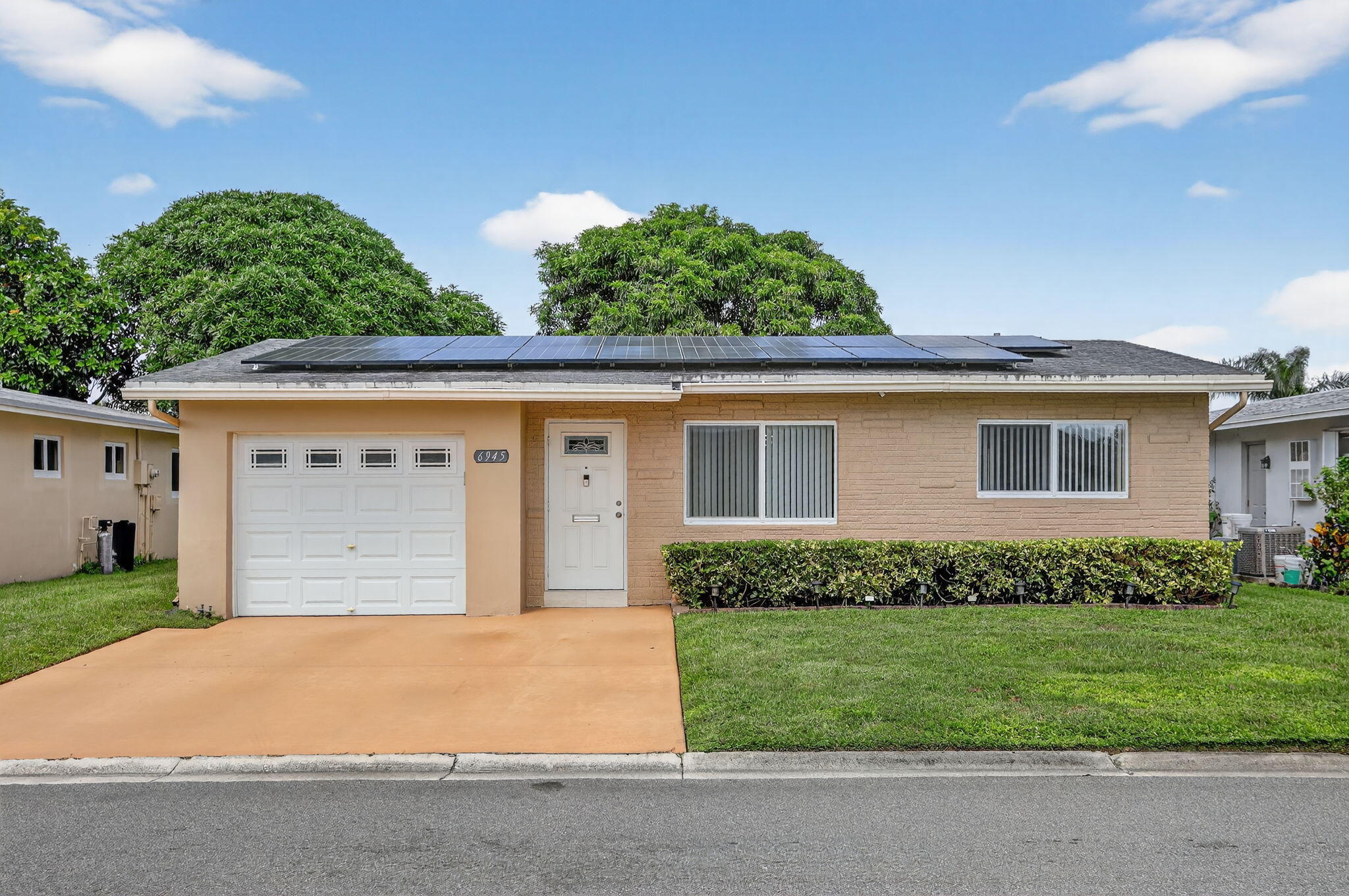 Charming Home in a 55+ Community Fully Remodeled! Two Bedrooms, two bathrooms, and one car garage.  It is equipped with solar panels installed on the roof, which can significantly reduce your electric bill.  The home also has a ready-to-use electric car charging setup.   Enjoy clean, mineralized drinking water with a high-quality filtration system that includes three separate water outlets-for the kitchen sink, coffee maker, and refrigerator.  Located in the desirable Paradise Gardens Section III community, residents enjoy access to a beautiful clubhouse with a swimming pool, gym, and various other amenities.  The community is ideally situated near Atlantic Blvd., State Road 7/U.S. 441, Lakewood Shopping Center, Margate Plaza, HCA Florida Northwest Hospital, and much more.