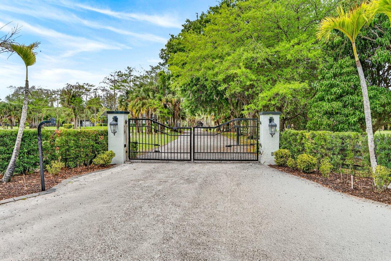 If you are seeking the ultimate in tranquility and privacy, look no further. Tucked away within the gated equestrian community of Deer Run, this exceptional 10-acre property offers a rare blend of comfort, functionality, and premier equestrian amenities. The beautifully renovated 3-bedroom, 2-bathroom home features wood-look tile flooring, granite countertops, stainless steel appliances, and impact windows and doors throughout. A large screened patio provides the perfect setting to relax and take in sweeping views of the lush, green acreage. Designed for the serious equestrian, the property is exceptionally well-equipped with an attached 6-stall barn featuring a tack room, half bath, and washer/dryer, as well as an additional 4-stall barn with tack room. Two recently added 5-stall barns, each with their own dedicated tack rooms, further enhance the functionality and flexibility of the setup. The grounds include 13 paddocks, a fully irrigated jumping field, and multiple riding arenas, highlighted by a regulation mirrored dressage arena with brand new GGT fiber footing. Additional features include full perimeter fencing, a large parking area, storage shed, and a whole-house generator. Ample space remains to expand even further if desired. A true equestrian paradise offering privacy, versatility, and top-tier amenities.