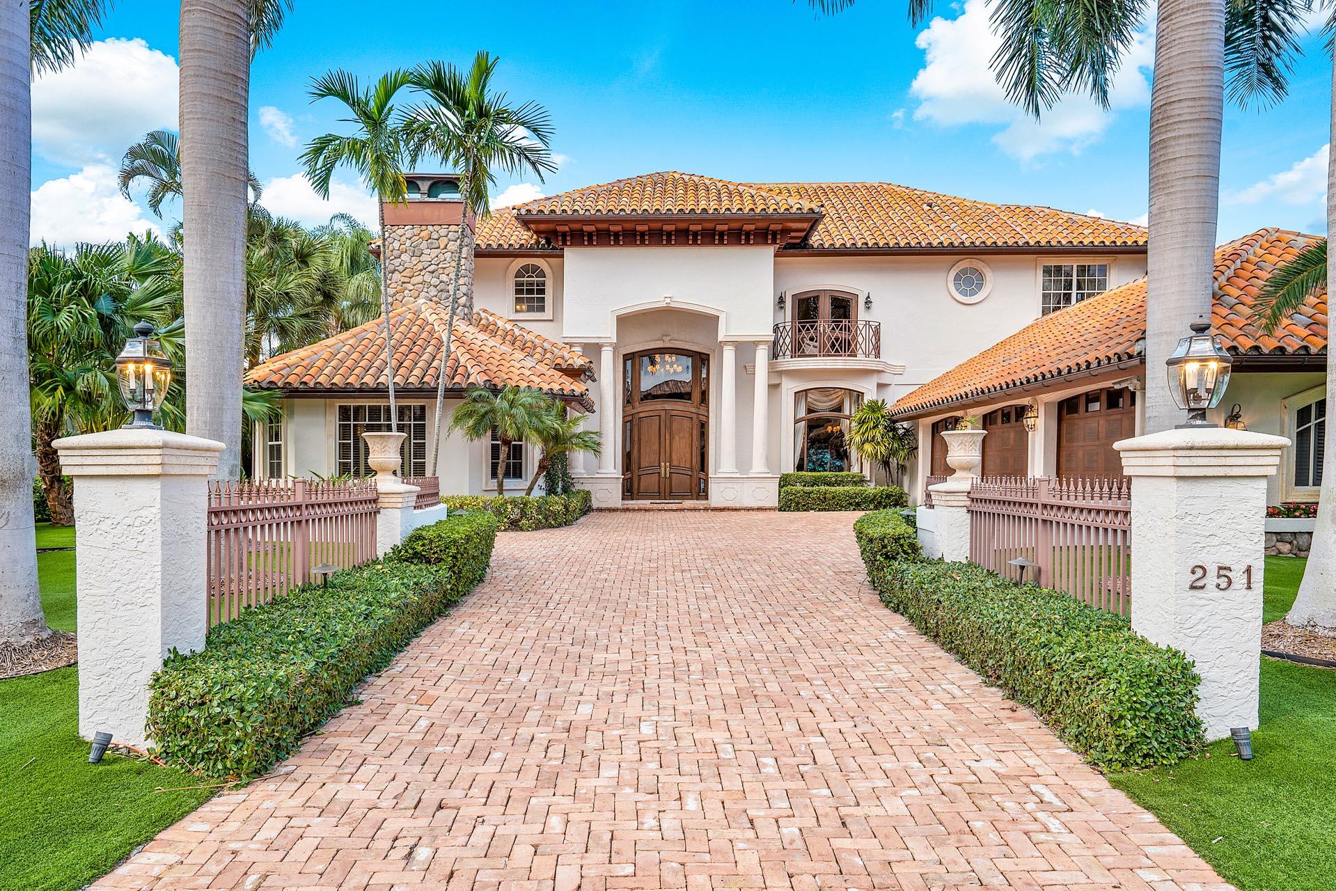 Introducing a waterfront masterpiece designed for those who value privacy and luxury living. This exceptional estate offers 89 feet on the widest canal in Royal Palm Yacht & Country Club and features a private dock with a boat lift, providing direct access to the Intracoastal. With sunny north exposure, the expansive outdoor living area boasts a heated free-form pool and spa surrounded by an elegant paver deck, creating an ideal space for relaxation or entertaining.

The large covered patio is perfect for al fresco dining and features a striking spiral staircase leading to the VIP suites and balcony, offering serene water views. Inside, the gourmet eat-in kitchen with a spacious island and walk-in pantry meets the culinary needs of any chef, while the formal dining room, highlighted by coffered ceilings, adds an element of grandeur to every meal.

The first-floor master suite offers a private retreat with a generous sitting area and a spa-inspired bathroom. Additional features include an elevator, premium impact windows and doors, and a low-maintenance turf yard, ensuring convenience and comfort.