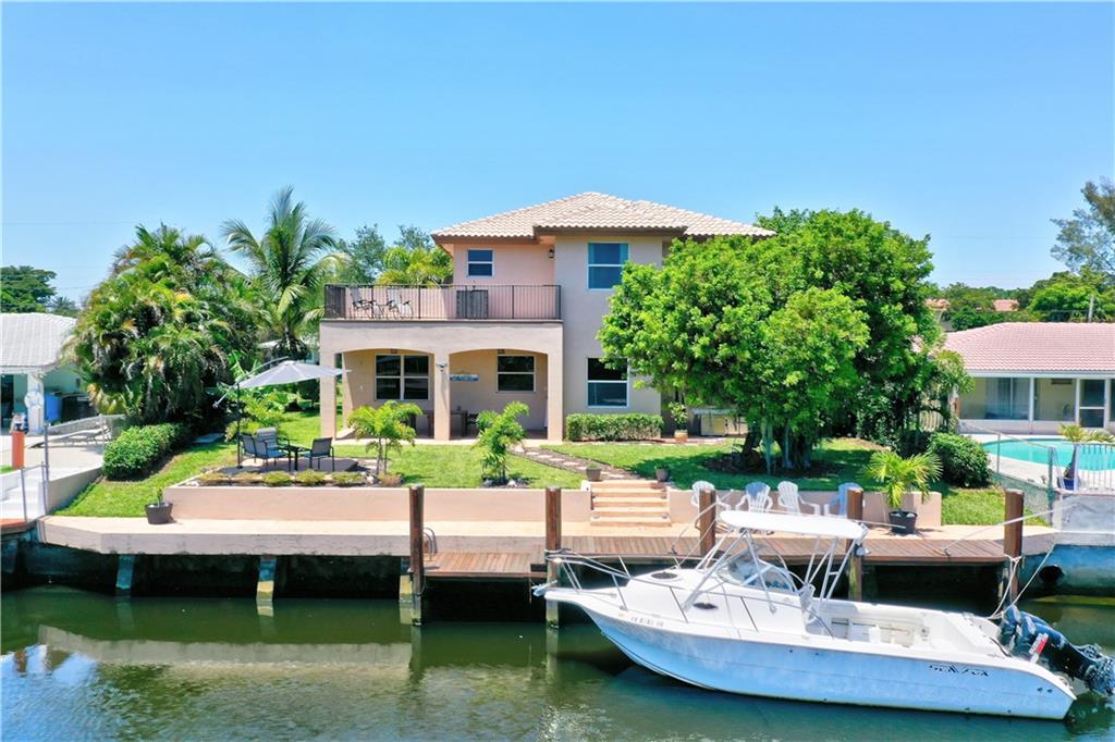 Welcome to your dream home in Pompano Beach! This stunning, updated residence built in 2008 offers the perfect blend of coastal charm and luxury. Nestled on a peaceful cul-de-sac, this ocean access home provides a serene and private retreat. As you approach the property, you'll be greeted by its beautiful curb appeal, featuring lush landscaping and a meticulously maintained exterior. Step inside, and enjoy a grand entrance 21 ft foyer and spacious floor plan, designed to maximize both natural light and the breathtaking views of the surrounding area. The bedrooms are spacious and well-appointed, providing a peaceful haven for rest and relaxation. The master suite is a true retreat, featuring a luxurious en-suite bathroom, walk-in closets and a private balcony overlooking the water.