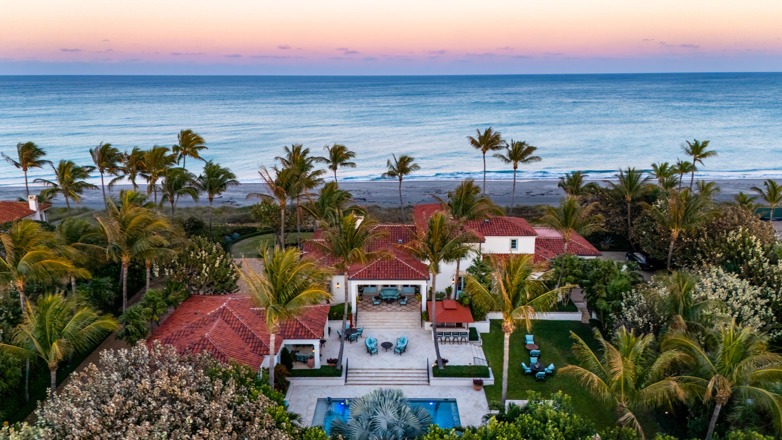 Rare and irreplaceable opportunity to own a legacy oceanfront estate in the very heart of prestigious Jupiter Island. Set on approximately 1.54 acres with nearly 230 feet of direct ocean frontage, this remarkable property represents one of the most coveted stretches of land on the entire island. Positioned in the central corridor of Jupiter Island -- widely regarded as one of the most desirable oceanfront locations in the world -- the estate captures the breathtaking turquoise waters of the Atlantic where the Gulf Stream flows closest to shore, creating the crystal-clear Bahamian blues that define this extraordinary coastline. From nearly every room in the residence, sweeping ocean views reveal an ever-changing seascape where dolphins play in the surf, sea turtles nest along the shore, tarpon glide through the shallows, and the rhythm of the Atlantic becomes part of everyday life. Built in 2014 with exceptional structural integrity and timeless design, the residence spans three levels plus a rare basement level -- an extraordinary feature on Jupiter Island made possible by the property's naturally high elevation. Designed with both elegance and functionality in mind, the estate blends classic Palm Beach architecture with transitional coastal sophistication, creating a style that is both enduring and refined. Upon arrival, the property immediately conveys its scale and privacy. Two separate entrances serve the estate -- a dedicated motor court entrance for the residence and garage, and a gracious main arrival designed for entertaining, with ample space to accommodate large gatherings while overlooking the Atlantic. The main residence features an extraordinary floor plan designed for both intimate family living and grand entertaining. Expansive living spaces flow seamlessly toward the ocean, while architectural details such as cypress ceilings, solid wood doors, and custom craftsmanship throughout the home reflect an uncompromising commitment to quality. The chef's kitchen, elegant dining room overlooking the Atlantic, refined living areas, and private office all anchor the main living level. The entire third floor is devoted to the primary suite, a private sanctuary accessible by elevator, offering spectacular panoramic ocean views and dual primary bathrooms designed with exceptional attention to comfort and luxury. A rare basement level provides additional flexibility and storage rarely seen in oceanfront properties in South Florida. Complementing the main residence is a beautifully designed guest house offering three spacious en-suite bedrooms, providing exceptional accommodations for extended family or guests. The guest house rivals many stand-alone luxury homes and reflects the same thoughtful design and architectural quality found throughout the estate. Outdoors, the property has been masterfully designed to balance entertaining, privacy, and protection from ocean breezes. A 36-foot resort-style pool anchors the outdoor living space, positioned strategically to allow for both elegant gatherings and relaxed family enjoyment while preserving the uninterrupted natural beauty of the Atlantic views. The expansive lawn stretches toward the ocean with gentle elevation and lush landscaping, creating a setting that is both picturesque and highly functional. A newly constructed private beach walkway leads directly to one of the most pristine stretches of sand on Jupiter Island, offering effortless access to the shoreline just steps from the home. The residence was created by an owner with a renowned eye for architecture and design, previously recognized in Palm Beach for creating one of the first notable estates featuring a substantial guest house and pool house concept that helped define modern Palm Beach living. That same thoughtful vision is reflected here -- a property designed not simply for today, but as a generational estate meant to endure for decades to come. With its extraordinary land size, rare ocean frontage, timeless architectural character, and exceptional structural integrity, this property represents more than just a home -- it is a long-term store of value in one of the most secure and desirable real estate markets in the world. Opportunities of this scale on Jupiter Island are increasingly rare. This is a property that can be enjoyed today, preserved for generations, and held as one of the most remarkable pieces of oceanfront real estate in South Florida. A true Jupiter Island legacy estate.
