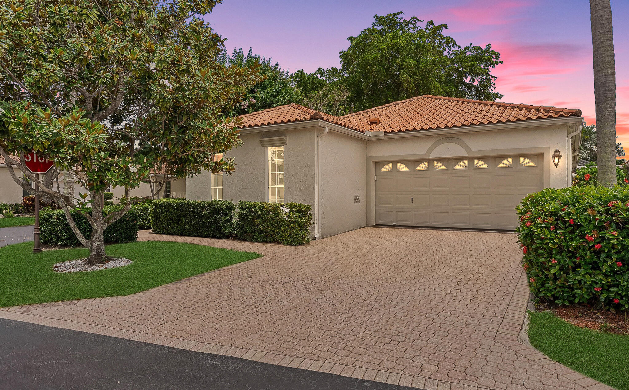 Exquisite pool home on a desirable corner lot in Boca Golf & Racquet Club. Bright open floor plan with vaulted ceilings, ceramic tile flooring, LED lighting, and a split-bedroom design. Gourmet eat-in kitchen features stainless steel appliances, center island with seating, and dining area with access to a private side patio. Spacious primary suite offers patio access and en-suite bath. Enjoy Florida living year-round from the screened patio with retractable awning, heated pool, and fully fenced backyard. HOA includes cable, internet, and lawn care. A-rated school district. Non-mandatory golf and social memberships available. Prime Boca Raton location just minutes from beaches, Town Center, and Mizner Park | ROOF 2014 | AC 2018 | WH 2025