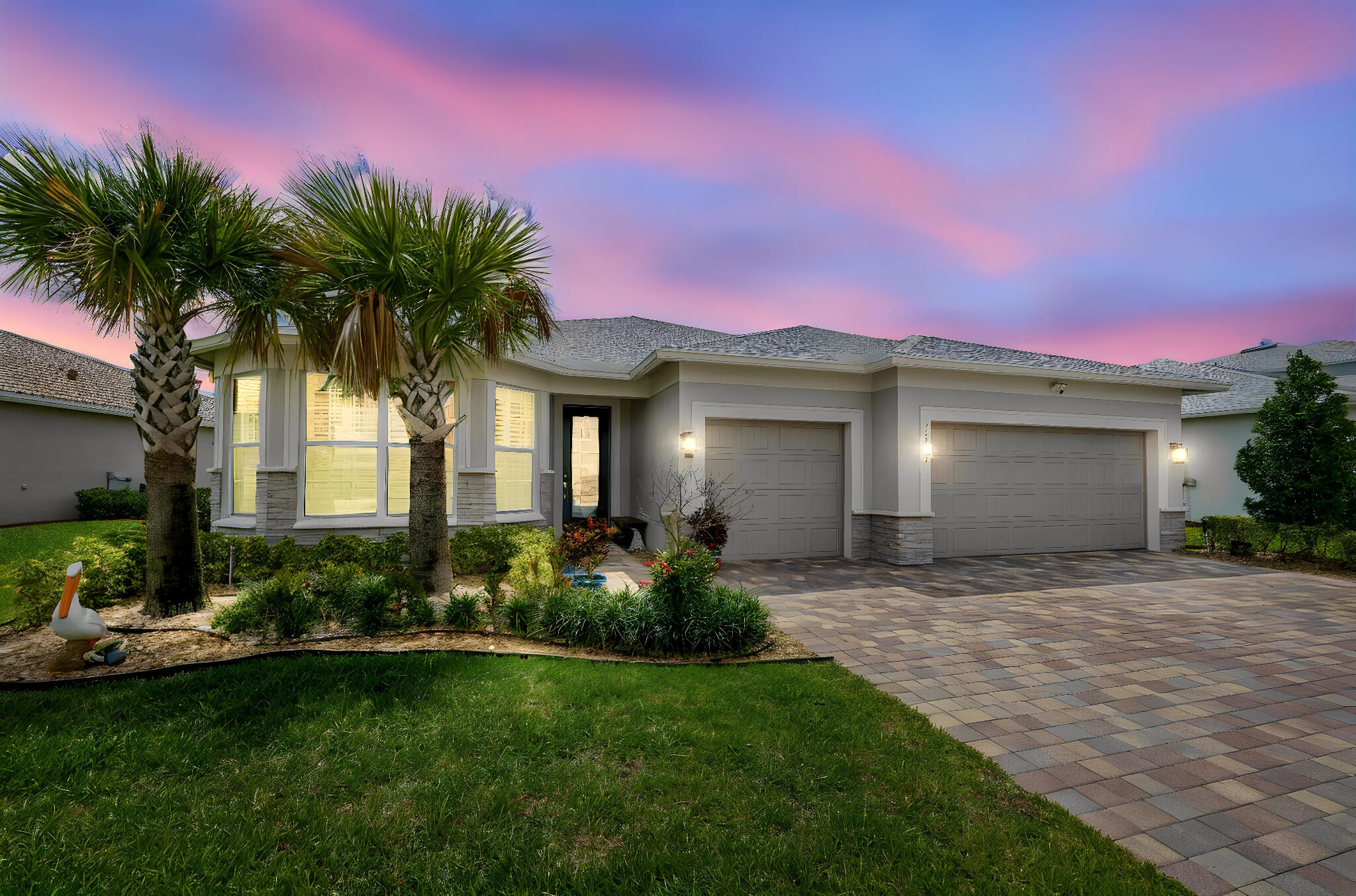 Welcome to this stunning, like-new 4-bedroom, 3-bath home with a 3-car garage located in the highly sought-after gated community of Heron Preserve at Tradition. Thoughtfully designed with luxury, comfort, and functionality in mind, this beautifully upgraded home showcases stylish wood-look tile flooring throughout, impact windows and doors, and expansive pocketing sliders that completely disappear when opened, creating seamless indoor-outdoor living. The gourmet kitchen is a true showpiece featuring high-end Whirlpool appliances, pull-out cabinet drawers, upgraded storage solutions, and an oversized walk-in pantry designed for maximum organization and convenience. Neutral designer tones and upscale finishes flow throughout most of the home, including crown molding, shiplap accents, and elegant board-and-batten details that add warmth and sophistication. The spacious primary suite offers a custom-designed closet system with exceptional storage and style. The oversized laundry room offers additional functionality and includes a washer and dryer. Plantation shutters throughout complete the polished, upscale feel.   The insulated 3-car garage is loaded with upgrades, including a mini-split A/C system, additional storage space, pull-down attic ladder, and stylish new coach lights. Additional smart-home features include a Blink video doorbell, motion lights with cameras, a keyless-entry front door, and keyless-entry garage access. The home also includes a 64,000-grain water softener and a whole-home filtration system. You will love the relaxing, fully screened porch with a sink and upgrades for an outdoor kitchen or gas grill. The backyard is fully fenced with park/preserve view!   Enjoy resort-style living in Heron Preserve, with amenities including a community pool, clubhouse, and beautiful lakefront surroundings. Located in the heart of Tradition, residents enjoy scenic walking and biking trails, parks, lakes, year-round events, concerts, farmer's markets, holiday parades, shopping, and dining. Conveniently located near I-95, the Florida Turnpike, and Cleveland Clinic, this home offers the perfect blend of luxury, lifestyle, and location.  ·         Second HOA covers Cable TV, 500GB internet, phone landline, whole house security system monitoring  ·         Quarterly HOA covers gated entrances, lawn service, tree trimming, irrigation, common areas, heated pool, picnic area, playground, sidewalks