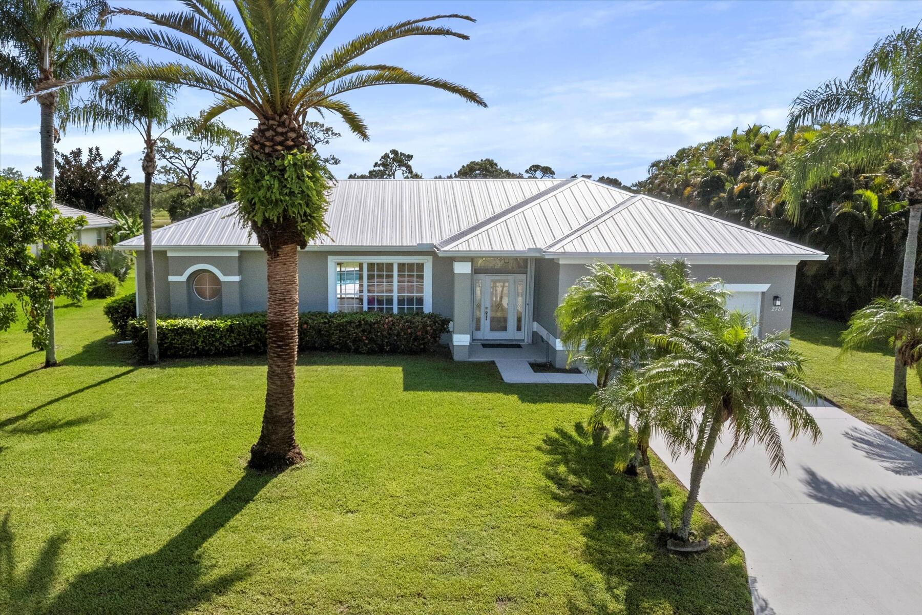 Welcome to your dream home, perfectly situated on a half-acre lot! This beautifully renovated 3-bedroom, 2-bathroom plus den residence offers the perfect blend of style, comfort and location. Every detail inside has been thoughtfully updated with modern finishes, creating a move-in ready oasis that feels brand new.Step inside to an open and airy floor plan featuring a formal living room, dining room, family room and versatile den that can easily serve as a home office. The gourmet kitchen shines with sleek cabinetry, quartz countertops, and stainless-steel appliances.Relax and unwind in the spacious primary suite, complete with a spa-inspired bathroom and generous closet space. Enjoy the Florida lifestyle with a sparkling private pool and expansive patio overlooking a lush golf course ideal for morning coffee or sunset cocktails. And don't miss the serene lake view right out front, offering the best of both water and fairway living.This home has it all: location, luxury, and lifestyle. Don't miss your chance to own this rare gem! New metal roof. Some images have been virtually staged to show the potential of the space.