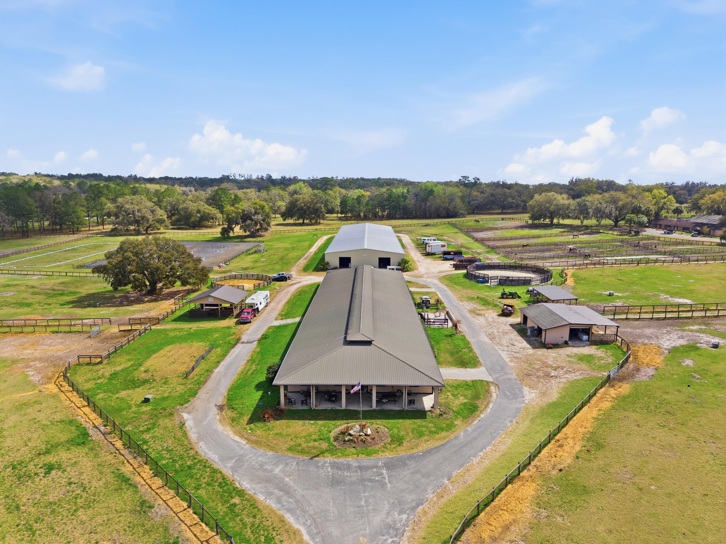 Bocoy Stables: A Premier Ocala Equine Masterpiece: Commanding 50+/- rolling acres within the Farmland Preservation Area, Bocoy Stables is a world-class facility designed for the Elite Equestrian. Boasting high-visibility frontage on Highway 27—just 5 miles from the World Equestrian Center—this estate seamlessly integrates professional utility with luxurious living. Elite Breeding & Professional Stabling: The infrastructure is a sanctuary for high-performance reproduction, featuring 61 total stalls equipped with mats, fans, and integrated fly-spray systems. The operation is anchored by a 26-stall specialized Reproduction Barn with a dedicated collection area and dual state-of-the-art laboratories. Premier boarding and training facility, very close to Ocala's World Equestrian Center. A separate 6-stall Foaling Barn offers 24/7 camera surveillance and onsite staff quarters, while the 22-stall Main Barn provides climate-controlled offices and tack rooms for seamless management. Championship Training Facilities: Trainers will excel with an 80' x 200' covered arena featuring premium GGT footing, irrigation, and a professional sound system. Outdoor amenities include a massive 200' x 300' arena with a viewing gazebo, two round pens, and a lush grass jump field with Dressage arena. The property is thoughtfully designed with indoor/outdoor wash racks, grooming stalls, and multiple laundry facilities to support a high-volume program. Luxury Residence & Support Housing: Beyond the stables, the 2,709 SF custom residence serves as a private oasis. The 3BR/4BA split floor plan features light-filled living spaces, elegant hardwood finishes, and an expansive screened pool and lanai. Exceptional staff and guest accommodations include two separate guest homes (3/2 and 1/1), a barn apartment, and a 40-foot RV carport with dual 50-amp hookups. Acreage Highlights: Prime Land: Secure, double-gated 50+/- acres with board-fenced pastures, loafing sheds, and majestic live oaks. Proximity: Immediate access to Hwy 27 and only minutes to WEC Ocala.